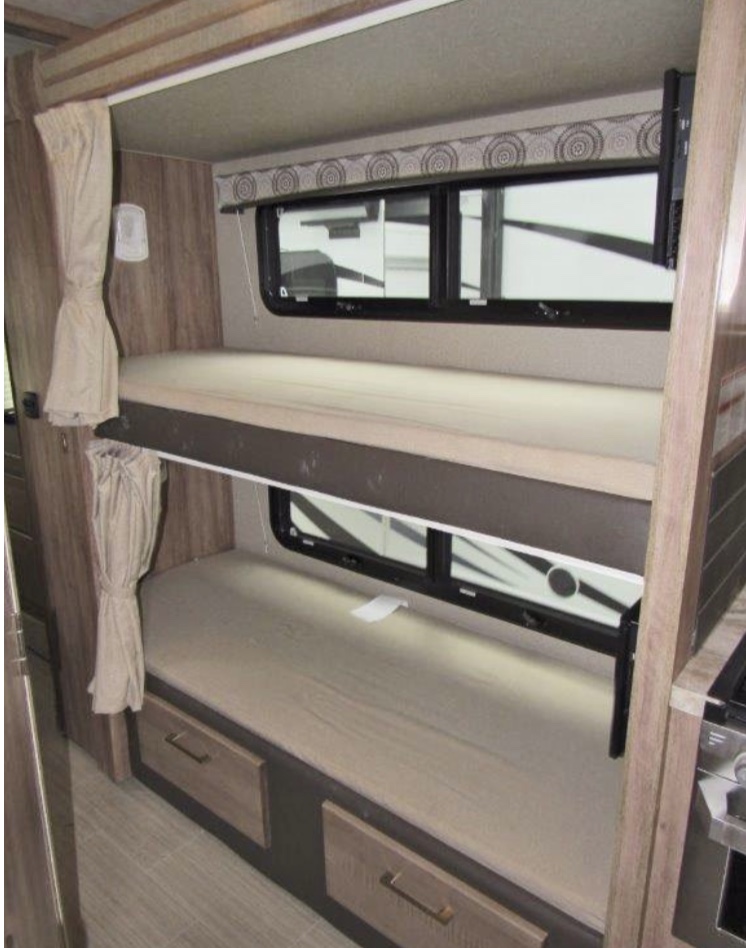 This RV rental features cozy bunk beds, a perfect sleeping area for family travel. Wood-look interior with windows & storage drawers.. Entegra Coach odyssey 2020