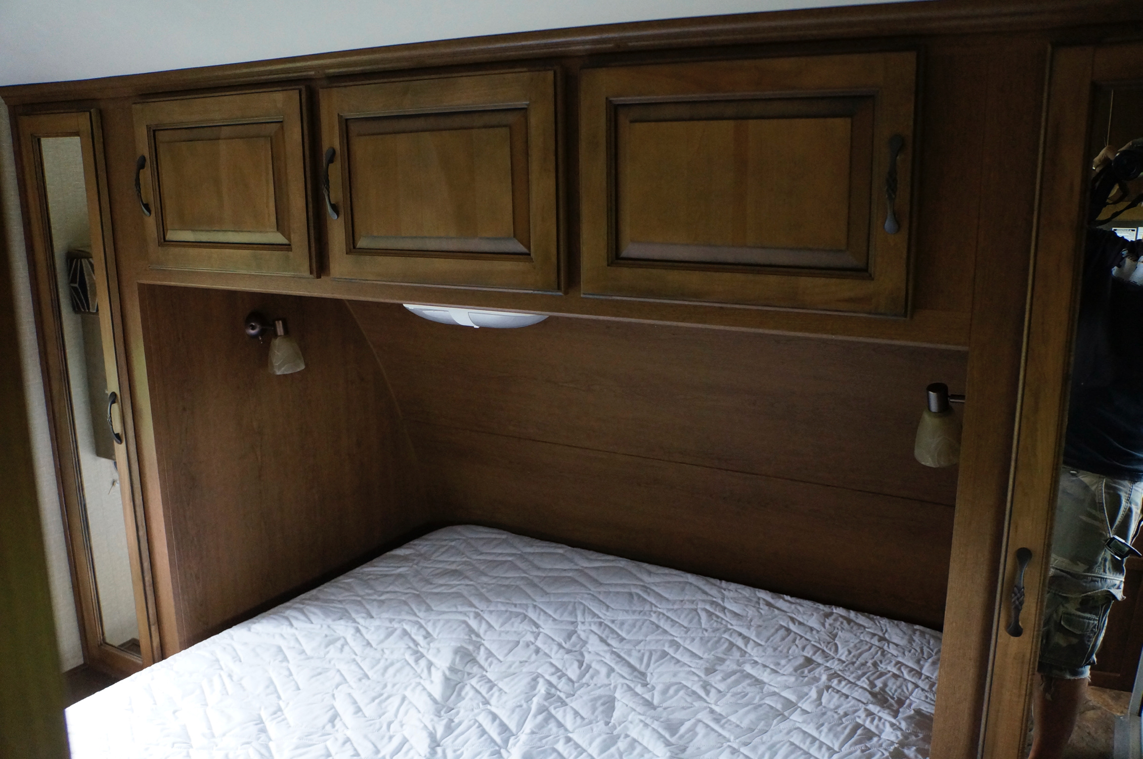 RV rental bedroom featuring a comfortable bed, overhead storage cabinets, and reading lights, perfect for travelers.. Cruiser RV Viewfinder Signature VS-28BHSS 2014