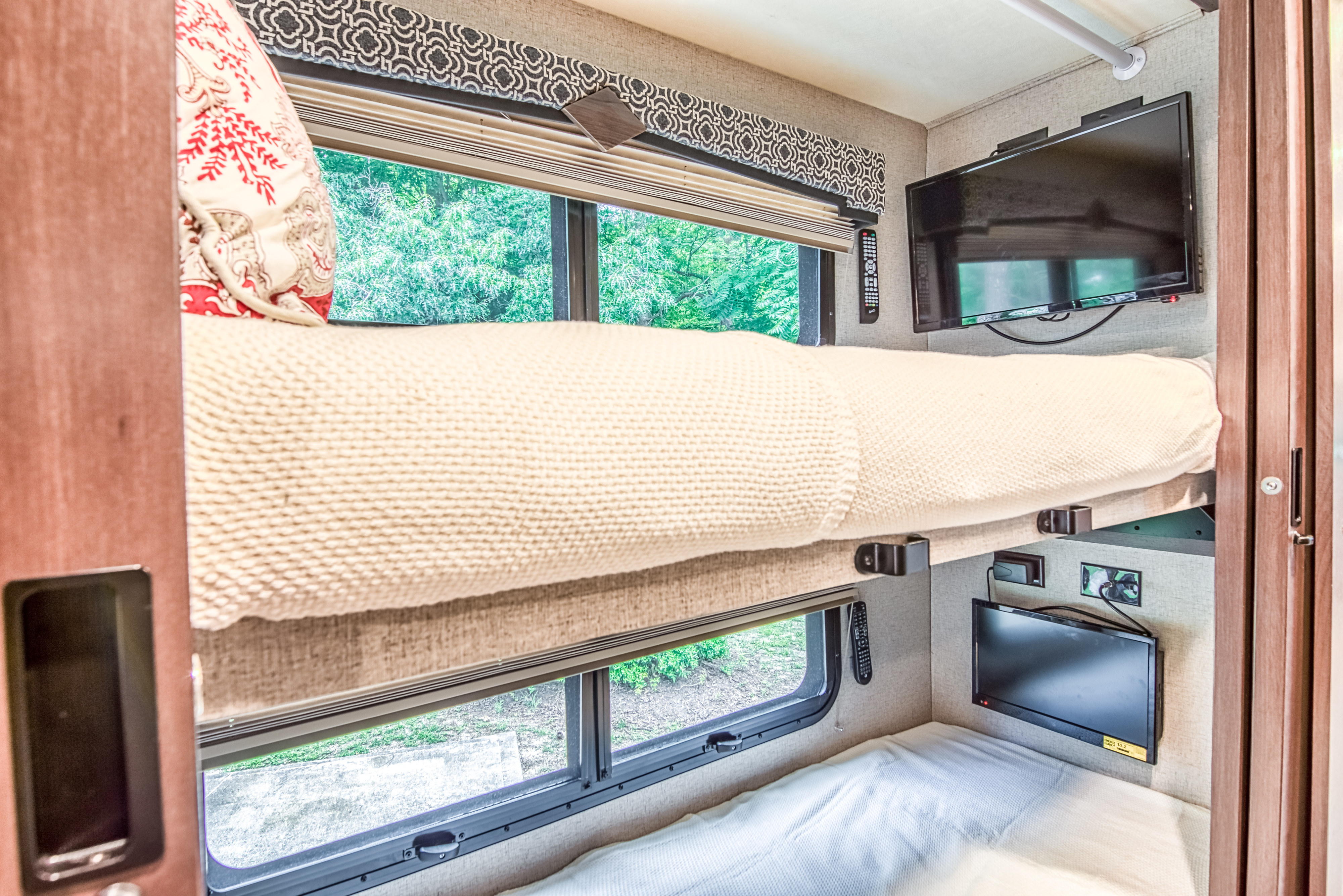 This RV rental features stacked bunk beds, each with its own TV and window, offering cozy sleeping & entertainment.. Other Hurricane 2020