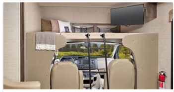 Spacious RV rental interior with a cozy cab-over bunk, TV, and ladder, offering a scenic view.. Jayco Redhawk 2020