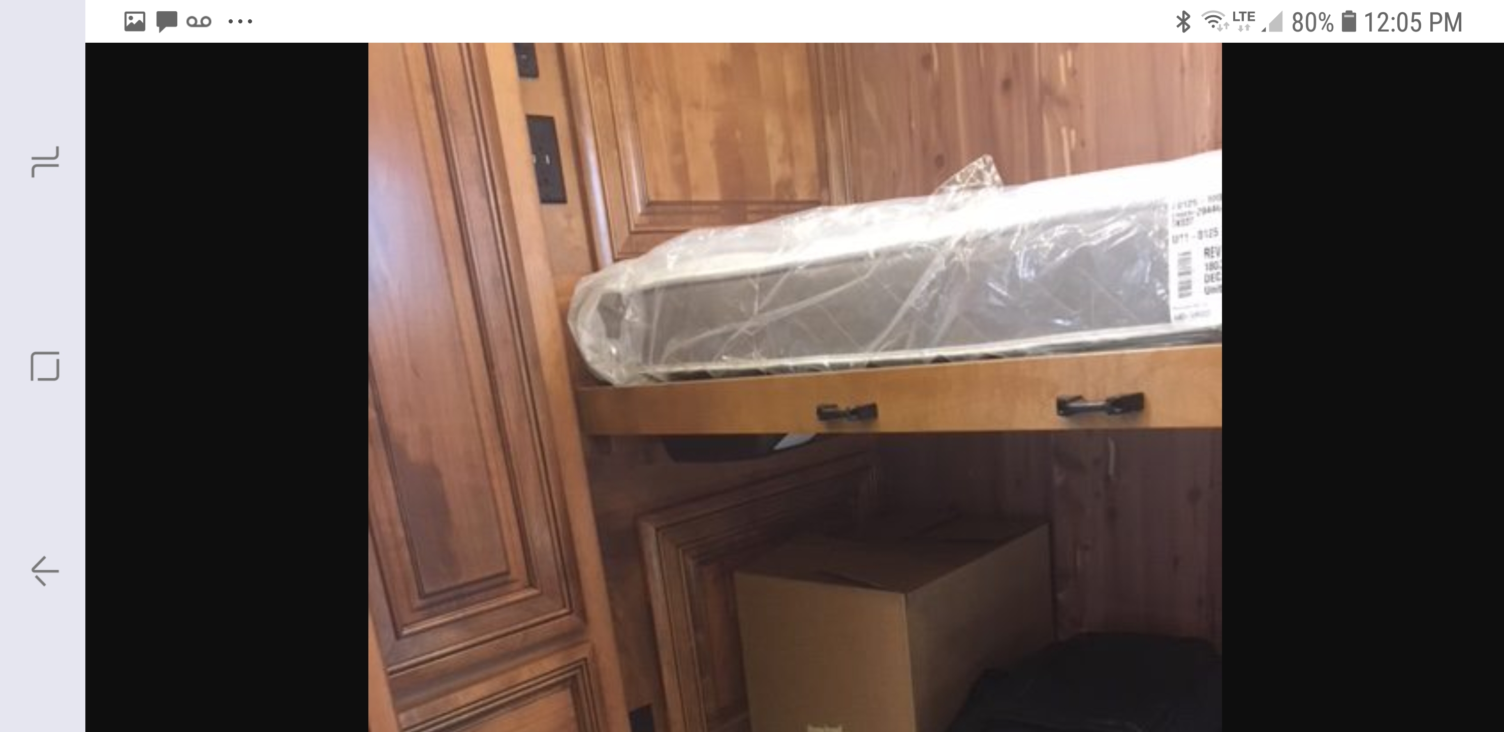 New, wrapped mattress on a bunk bed in an RV rental, with ample storage space below for your gear.. American Coach 42B 2019