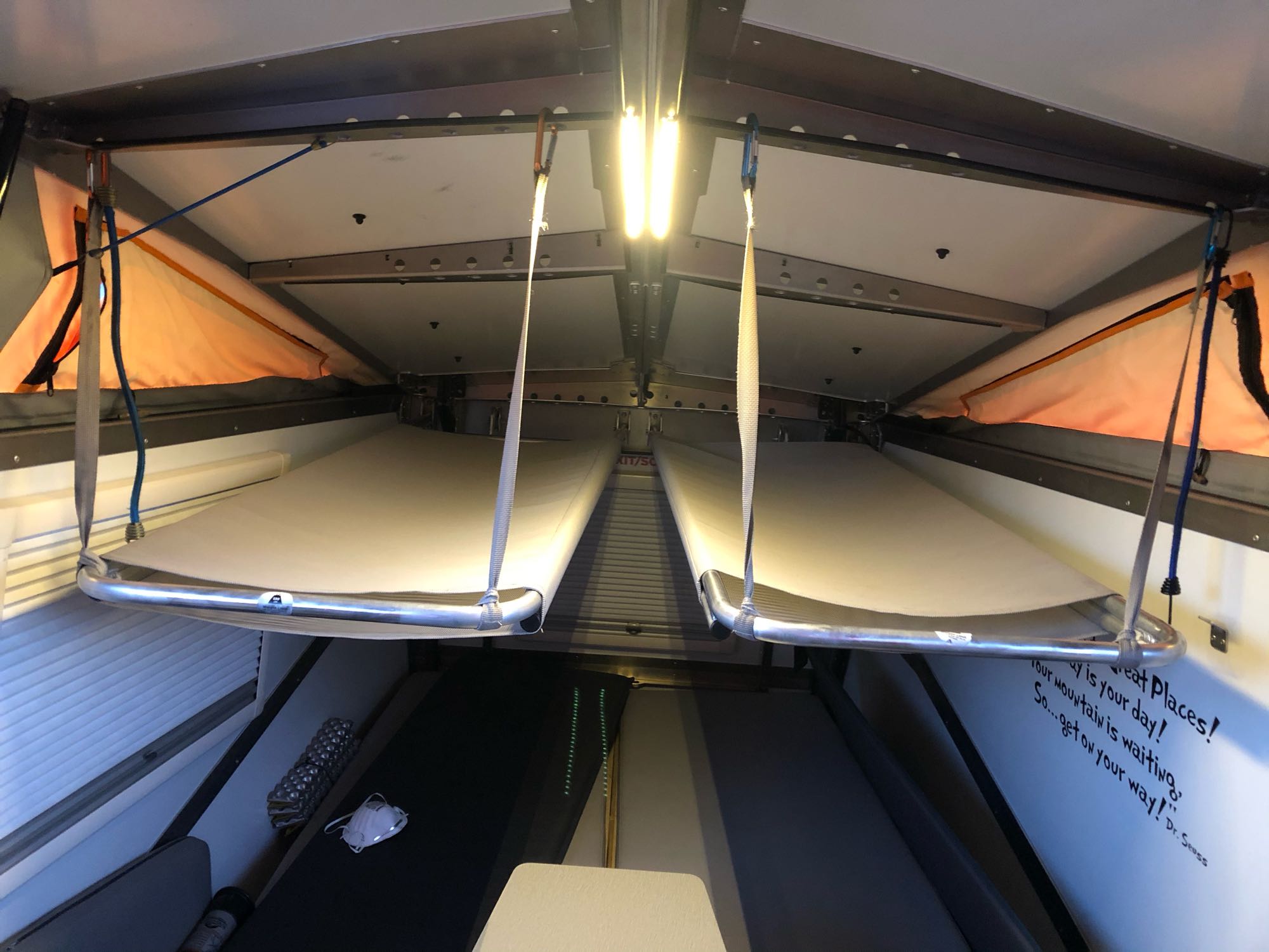 Inside an RV rental: two hanging bunk beds create a compact, adventure-ready sleeping area with inspiring Dr. Seuss decor.. TAXA Outdoors Cricket Camper 2016