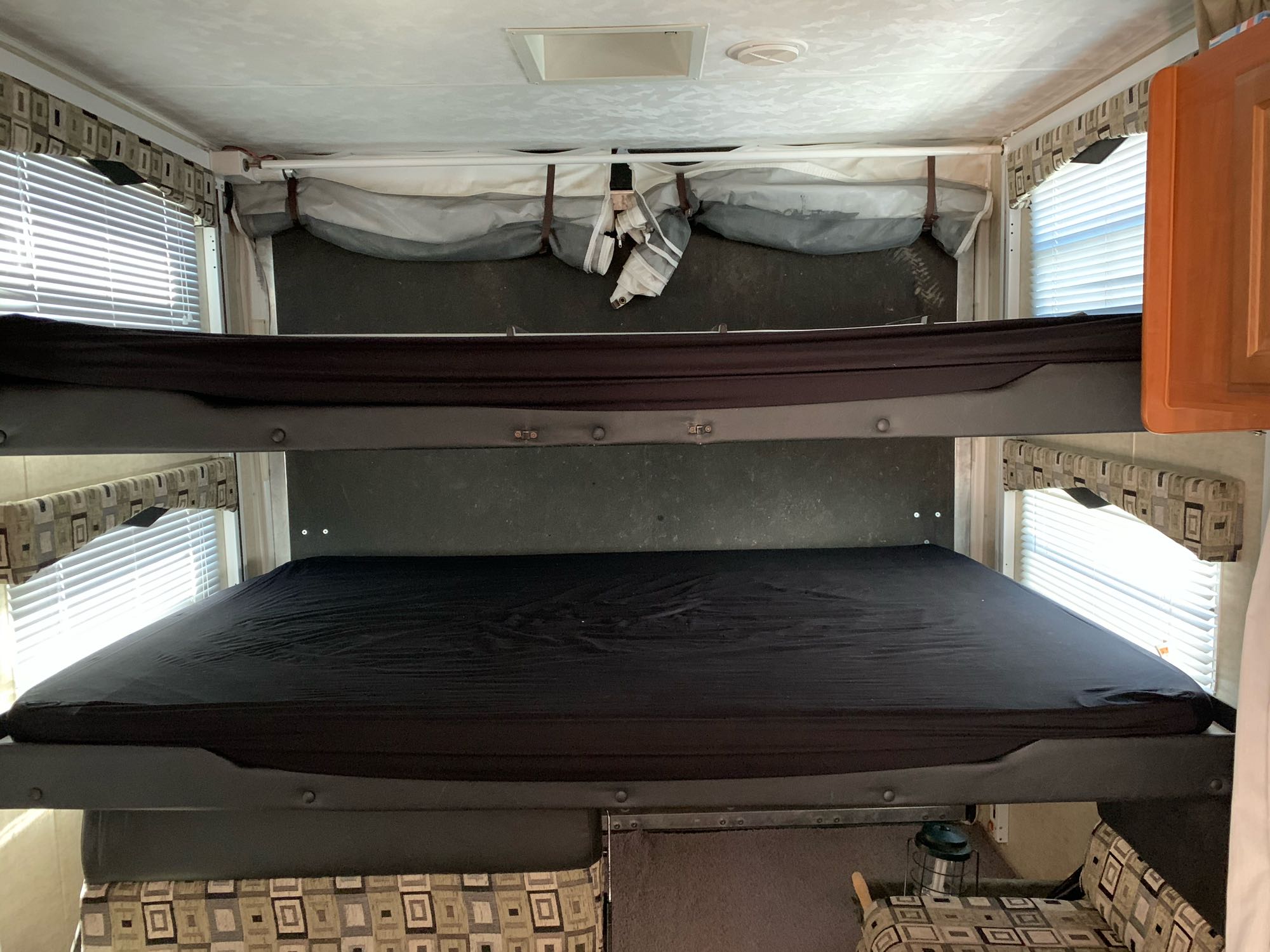 RV rental with stacked bunk beds and a pop-out sleeping area. Bright interior with windows.. ForestRiver Sandstorm 2008