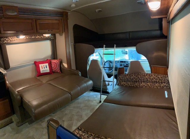 This RV rental offers a spacious interior with a convertible sofa, cab-over bed, and rear sleeping area.. Jayco Redhawk 2016
