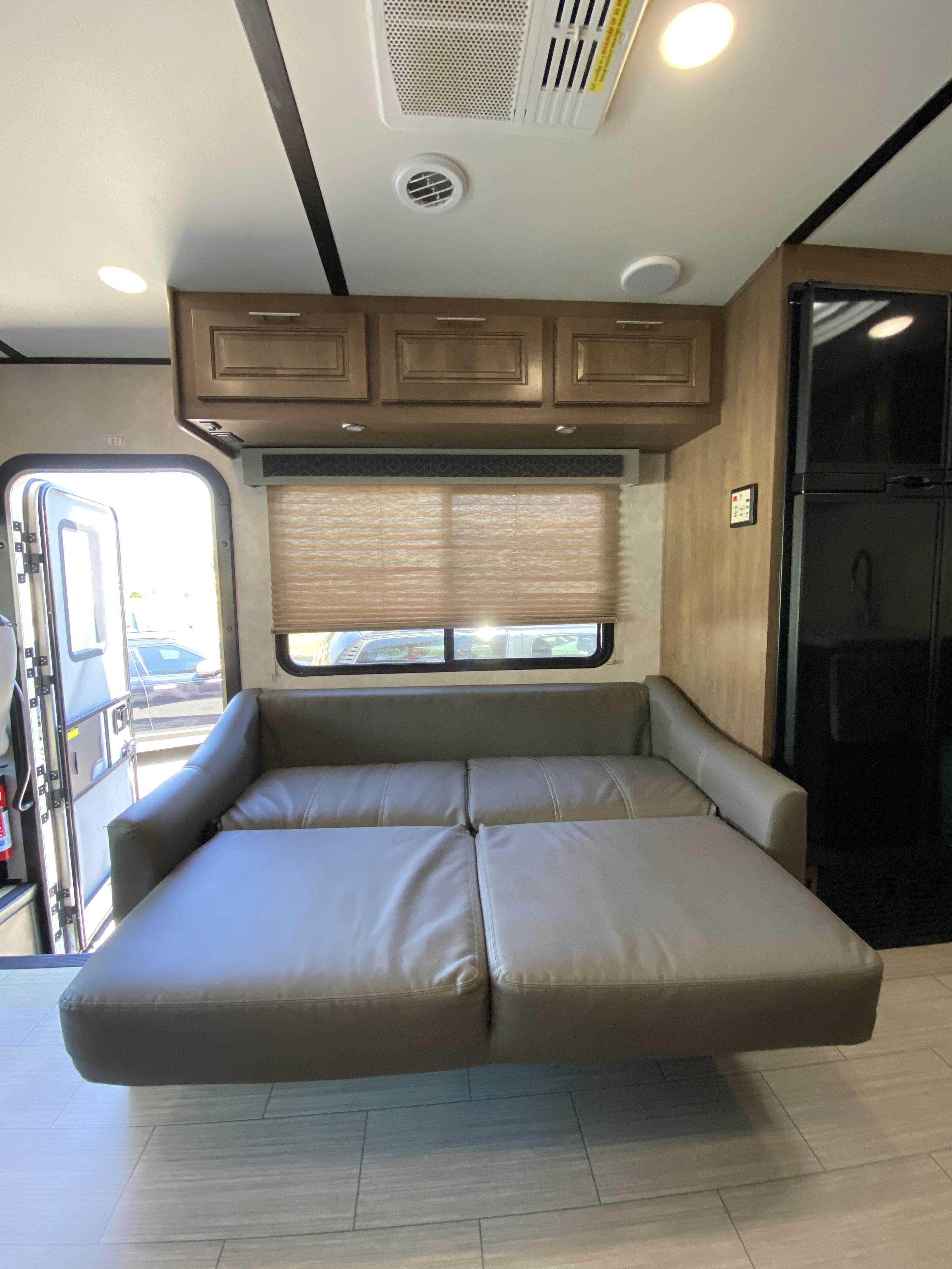 RV rental: Bright interior featuring a versatile sofa bed, wood cabinets, and a refrigerator, ready for your road trip comfort.. Forest River FR3 2021