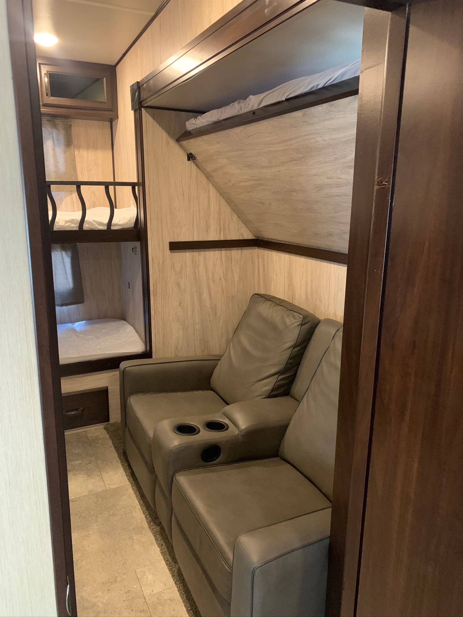 Cozy RV rental interior showcasing triple bunk beds, two reclining seats, and a bright, functional layout.. Palomino Columbus 2018