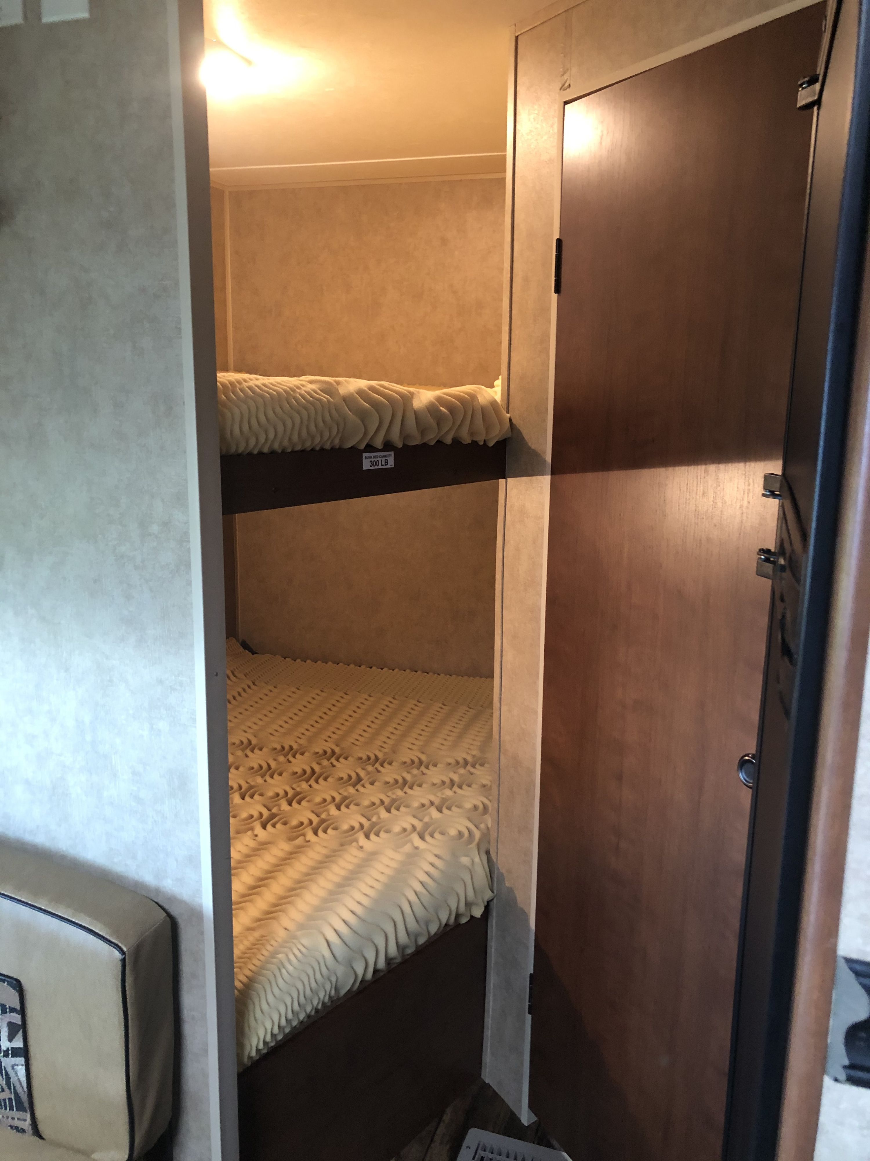 RV rental bunk beds feature textured foam toppers, ideal for compact sleeping spaces. Upper bunk rated 300 lbs.. Dutchmen Other 2013