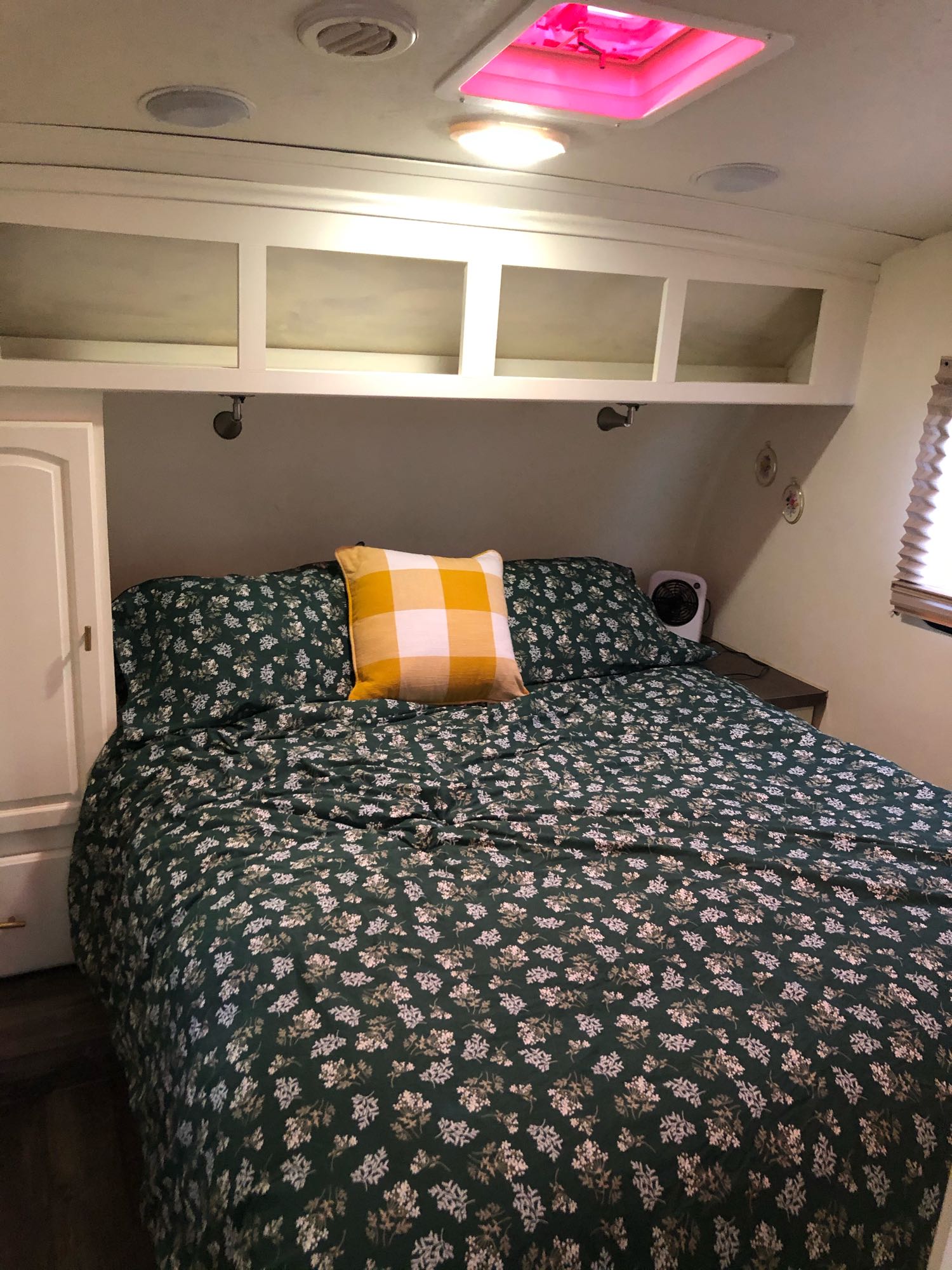Inviting RV bedroom interior: a comfy floral bed, ample overhead storage, and ceiling amenities. Ideal for your next rv rental adventure.. Forest River Flagstaff Classic Super Lite 2014