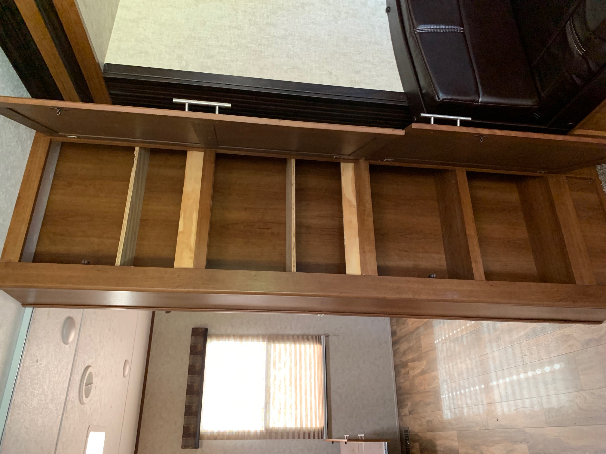 This RV rental features an open, spacious wooden overhead storage cabinet with dividers, perfect for organizing.. Forest River Other 2017