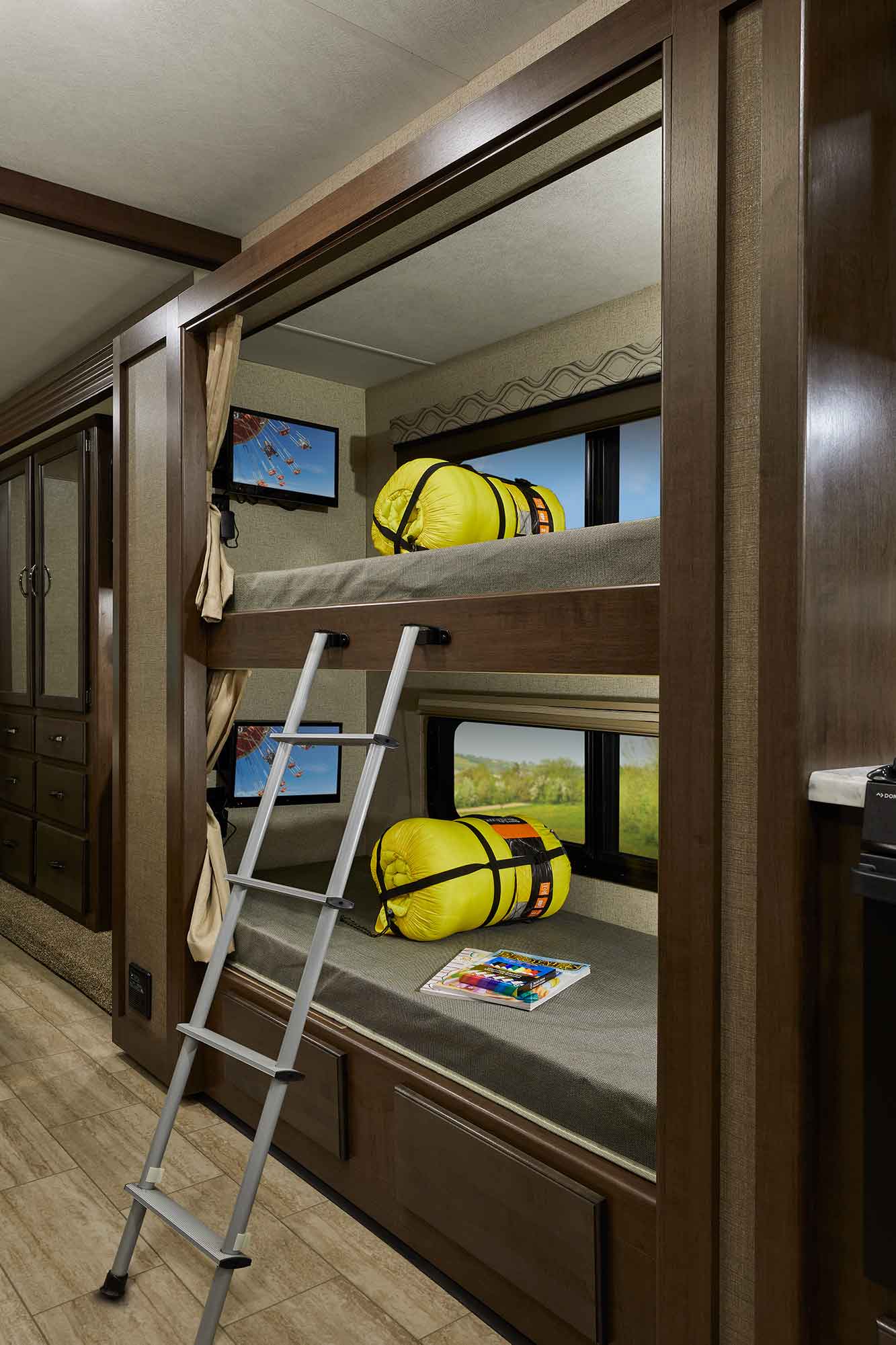 RV rental interior with cozy bunk beds, individual TVs, and storage, perfect for family travel adventures.. Thor Motor Coach A32 Freedom Traveler 2020