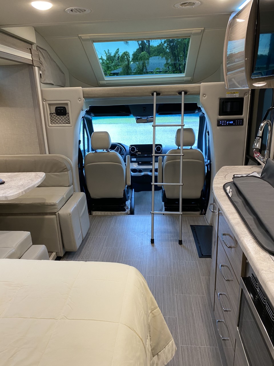 This RV rental offers a well-appointed interior: front cab, overhead bunk, kitchen, dinette, and comfortable bed. Perfect for travel!. Thor Delano 2021
