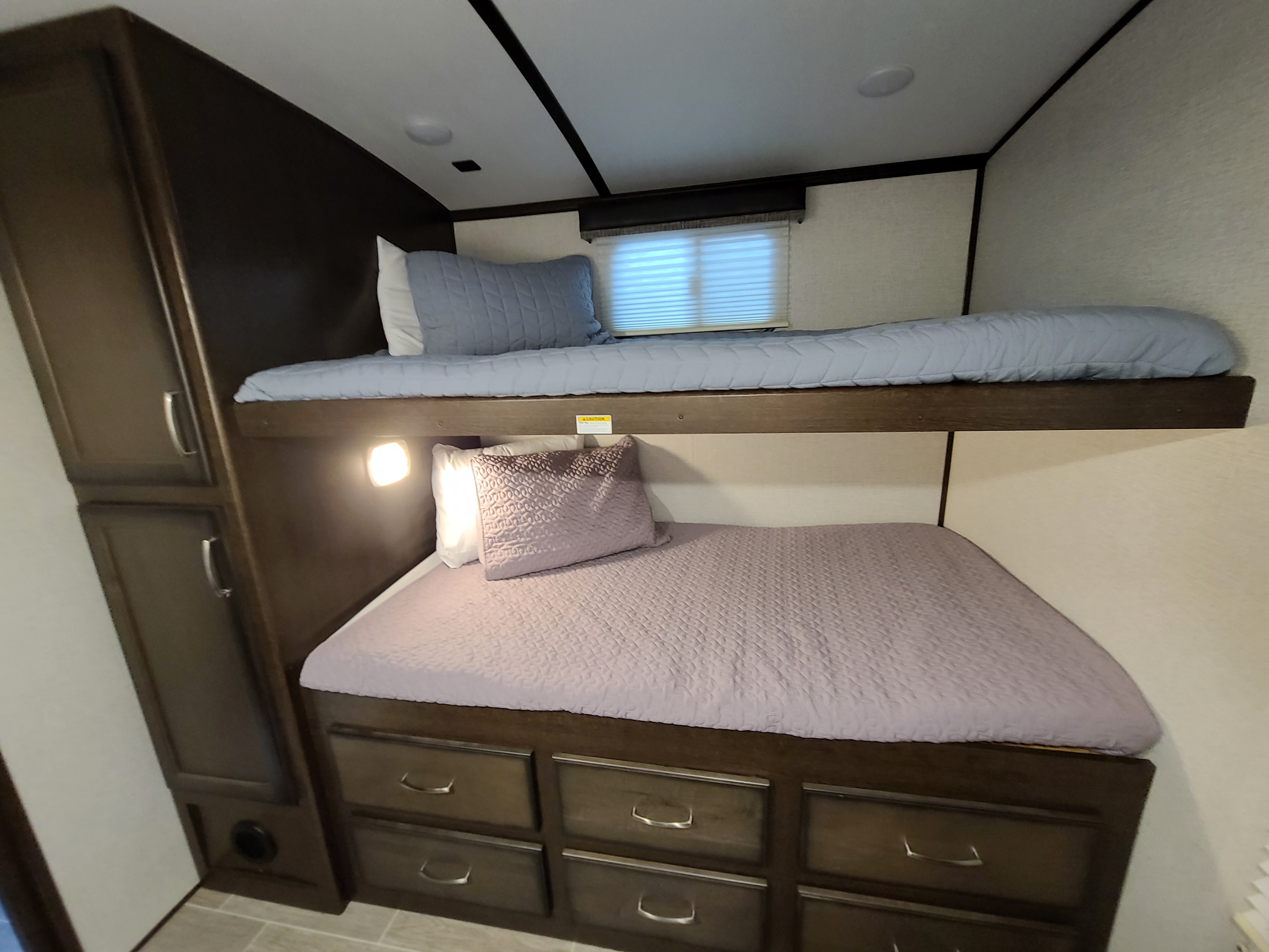 RV rental bunk beds offer comfy sleeping with built-in storage drawers and a cabinet for convenience.. Dutchmen Other 2020