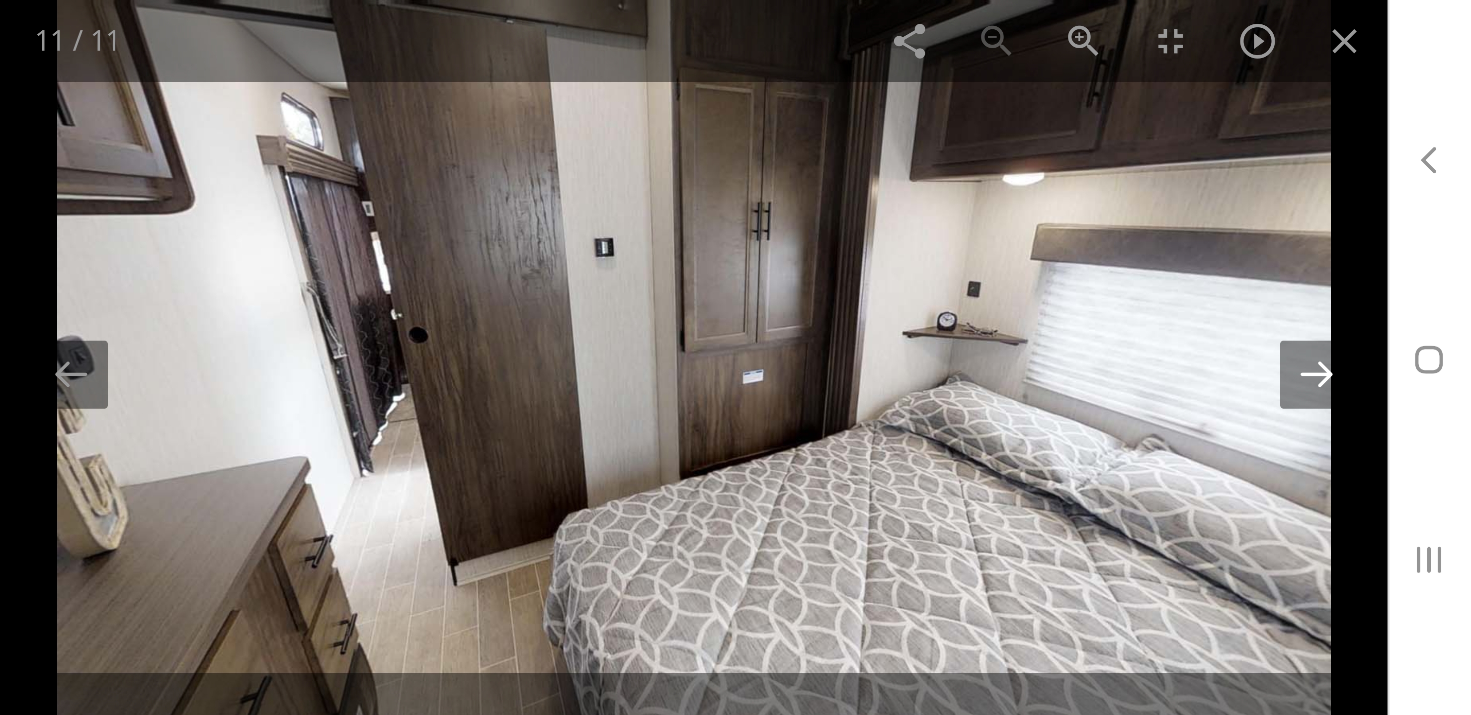 RV rental interior: a cozy bedroom features modern wood finishes, a patterned bed, and compact storage.. forest river cherokee 39ca 2019