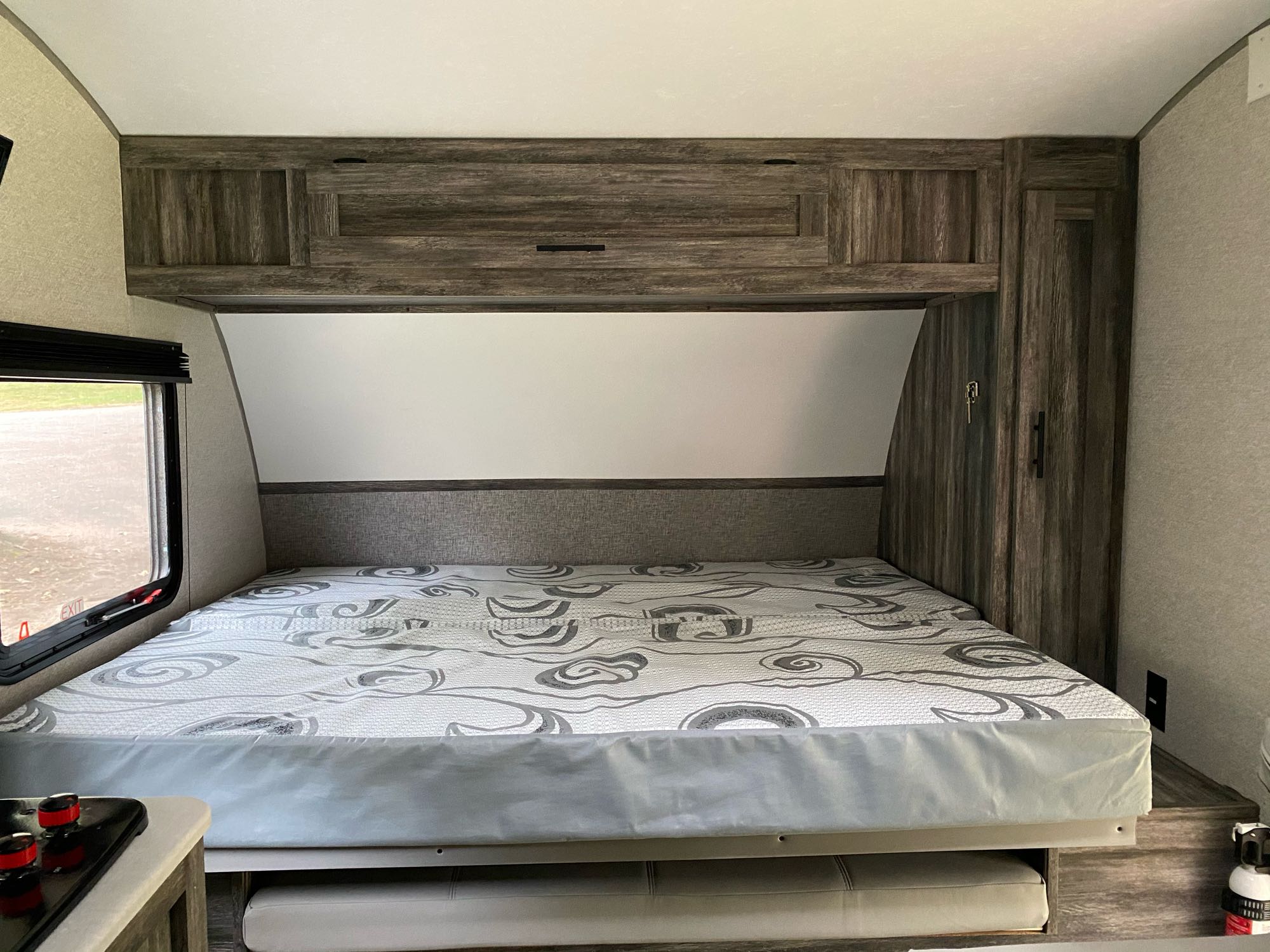 RV rental interior: cozy bedroom with a comfortable mattress, overhead storage, and wardrobe. Perfect for your travels.. Forest River Other 2021