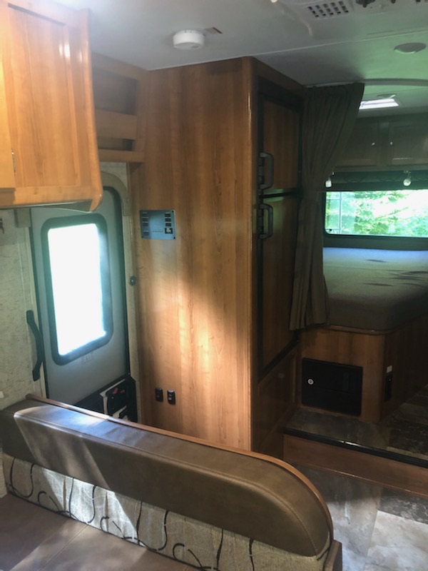 Step inside this cozy rv rental! Features include a dinette, wood cabinets, fridge, and private bedroom with a curtain.. Coachmen Leprechaun 2018