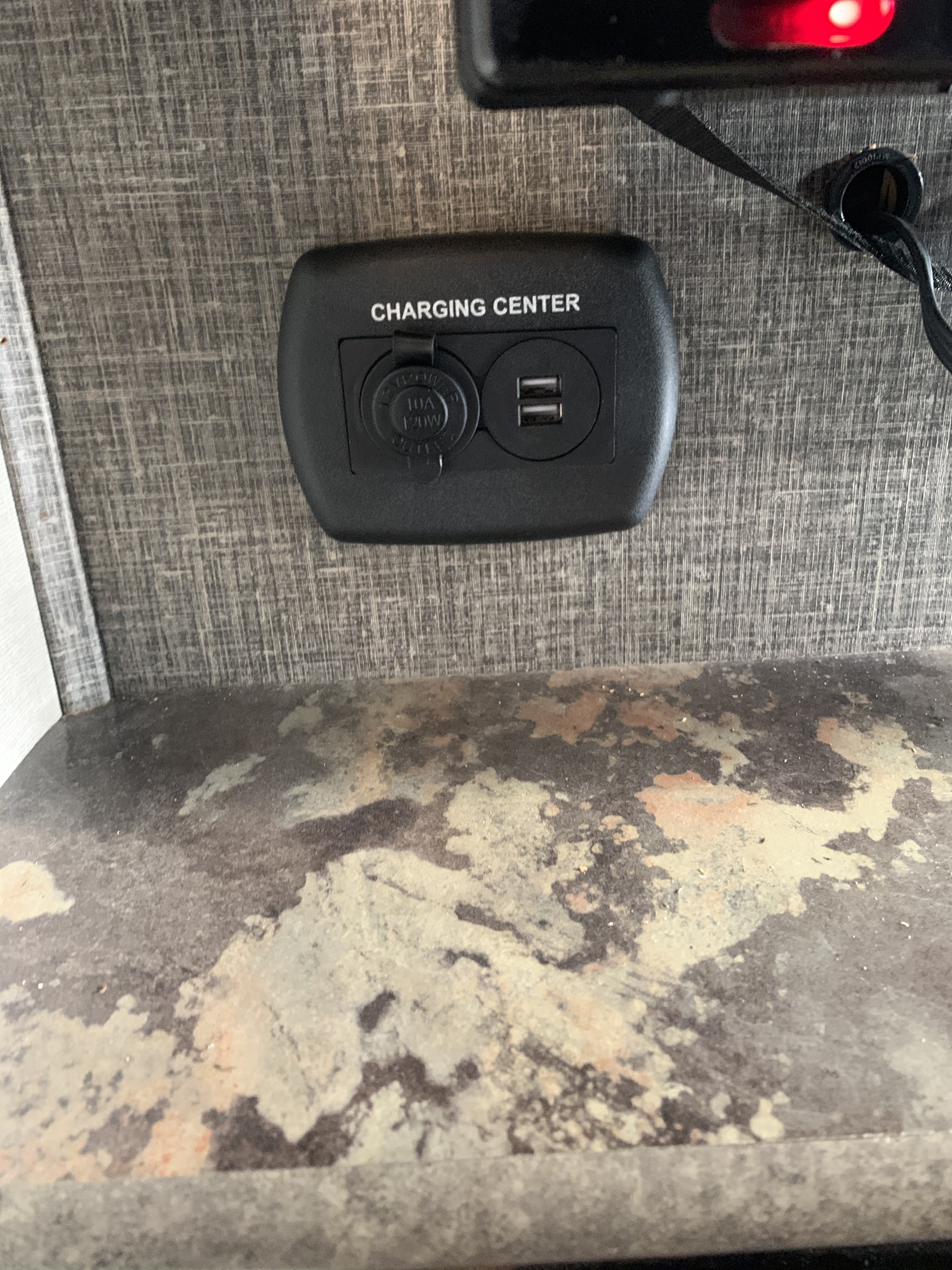 Integrated RV rental charging center: a black unit with a 12V outlet (10A, 120W) and dual USB ports for charging mobile devices.. Keystone Cougar 31SQBWE 2015