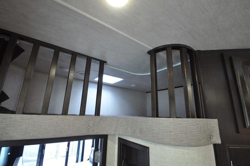 RV rental interior: cozy loft bed with safety railing. Notice the skylight & ceiling light maximizing space.. Heartland Road Warrior 2017