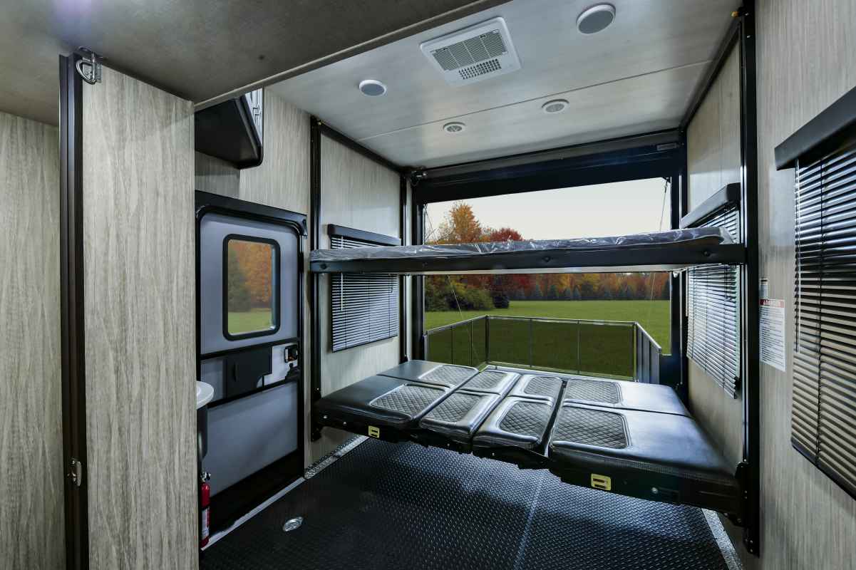 RV rental interior: Versatile toy hauler with convertible beds & rear patio access, ideal for adventure.. Heartland Road Warrior 2017
