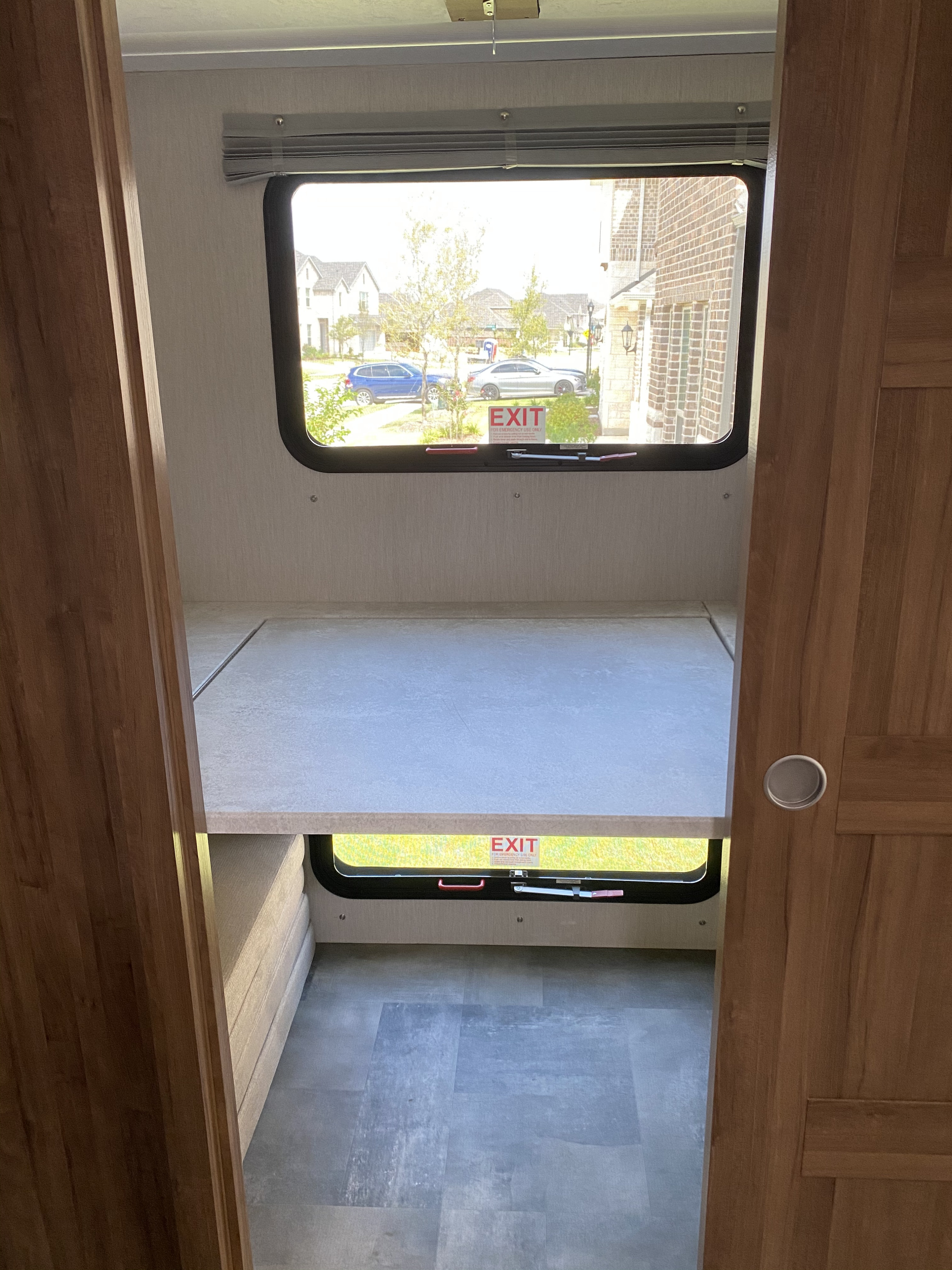 RV rental bunk beds with emergency exit windows & street view. Comfy sleeping for adventure travel.. Coachmen Mirada 2021