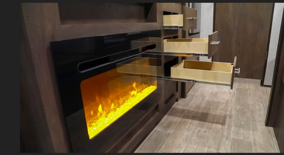 Explore your RV rental: Built-in electric fireplace and convenient pull-out storage drawers in the living area.. Dutchmen Coleman 2020