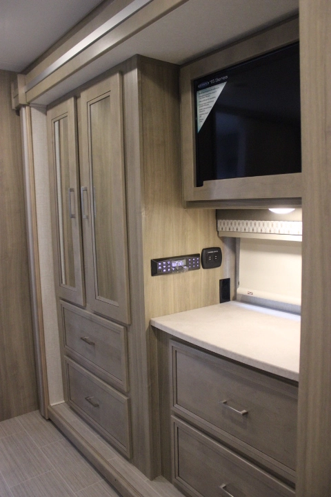 RV rental interior with light wood cabinets, wall-mounted TV, counter space, and integrated media systems.. Other Other 2019