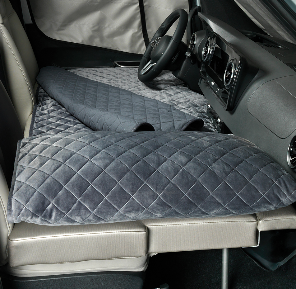 Plush, quilted sleep mats transform an RV rental into a comfortable resting space, ideal for travel.. Airstream Atlas 2021