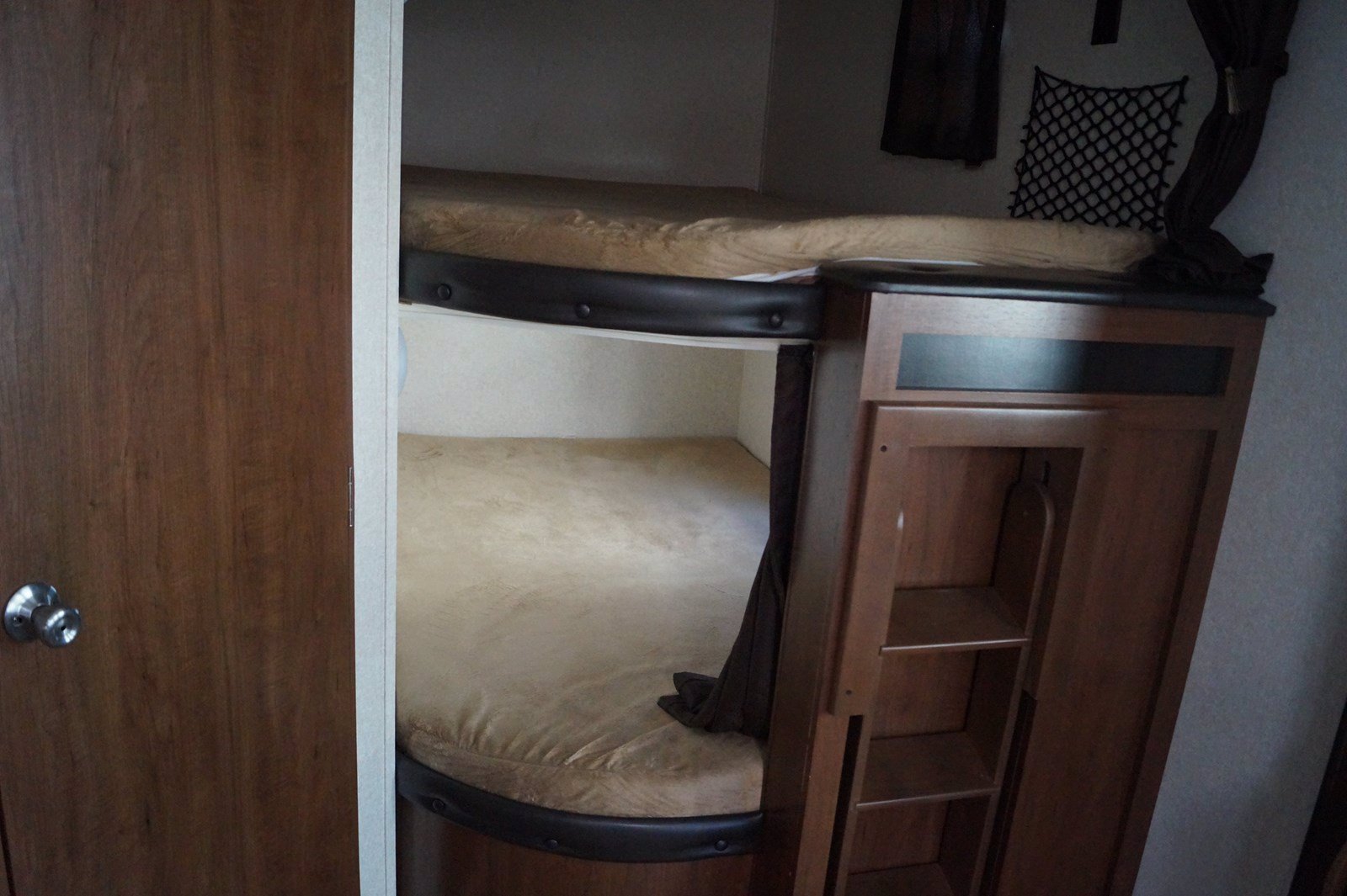 This RV rental features a cozy bunk bed setup with storage, perfect for compact sleeping arrangements.. Jayco Jay Flight 2017