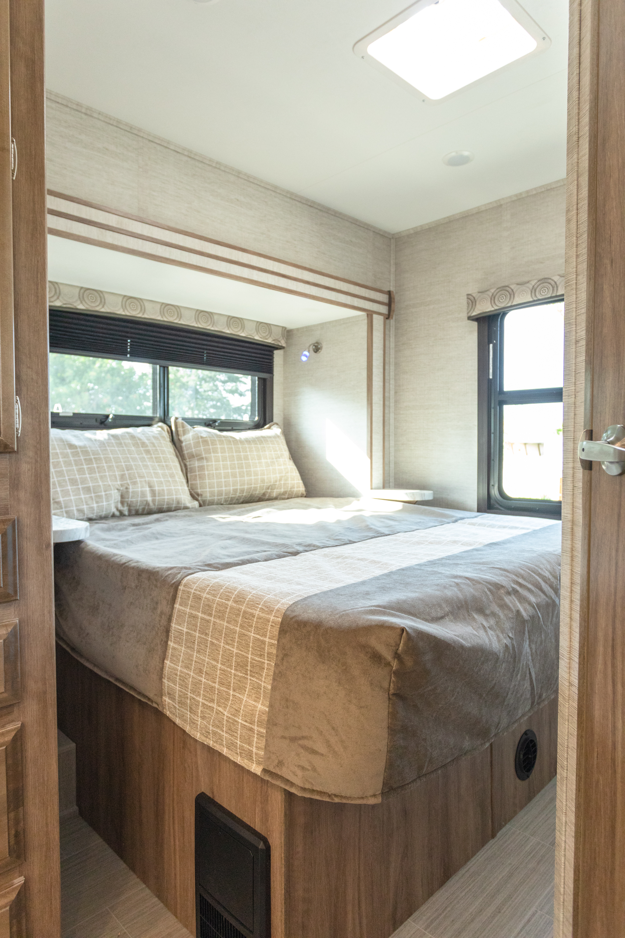 Step inside this inviting RV rental bedroom. Features include a comfortable bed, multiple windows, and a bright interior.. Entegra Coach Odyssey 26D 2021