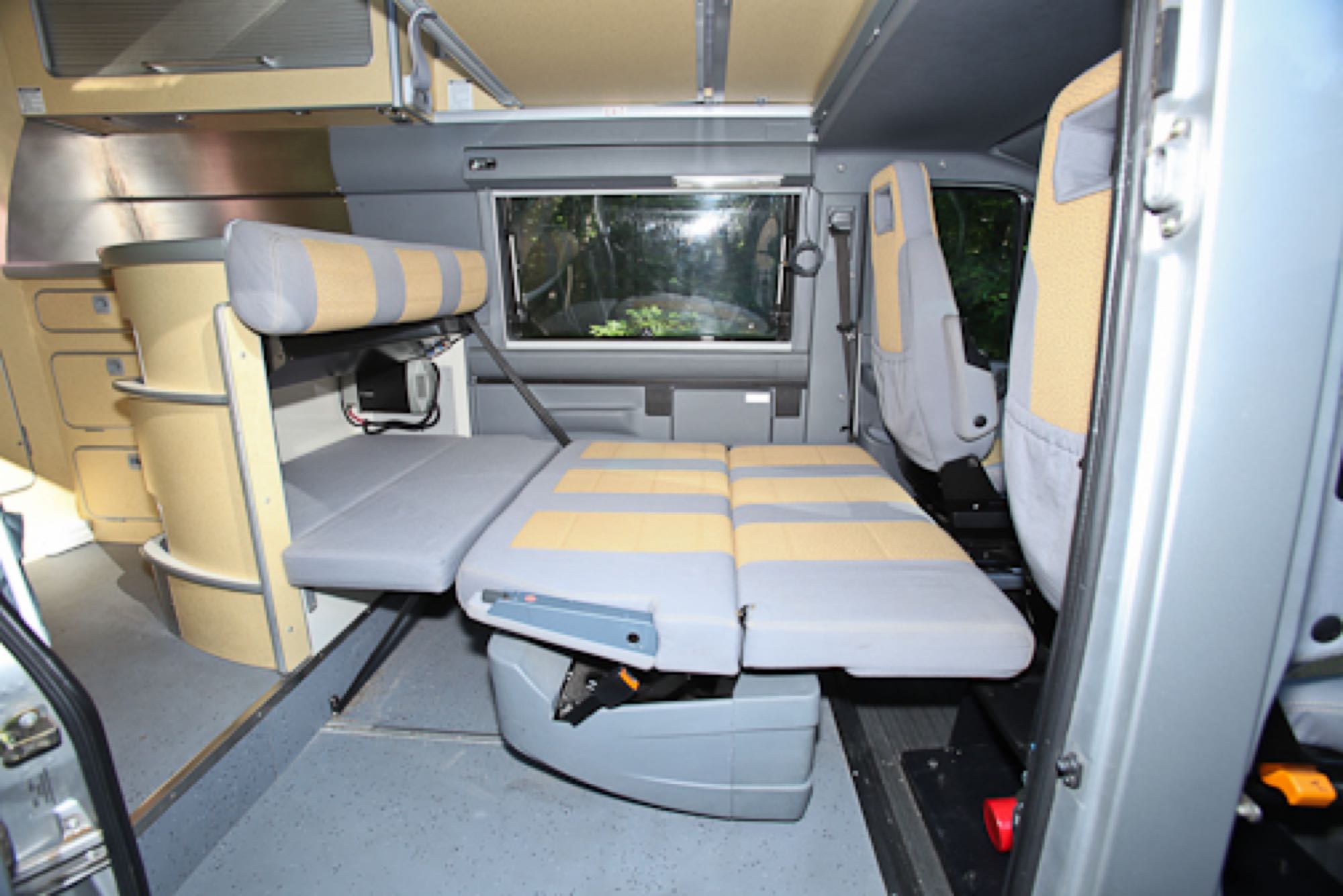 RV rental: Flexible camper van interior with convertible bed/seating, rear window, and side storage for travel.. Airstream Westfalia 2005