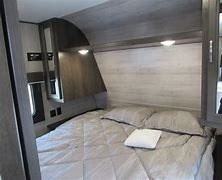 Comfortable RV rental bedroom featuring a queen bed, built-in lights, and modern wood finishes for a cozy trip.. Jayco Jay Flight SLX 8 267BHS 2021