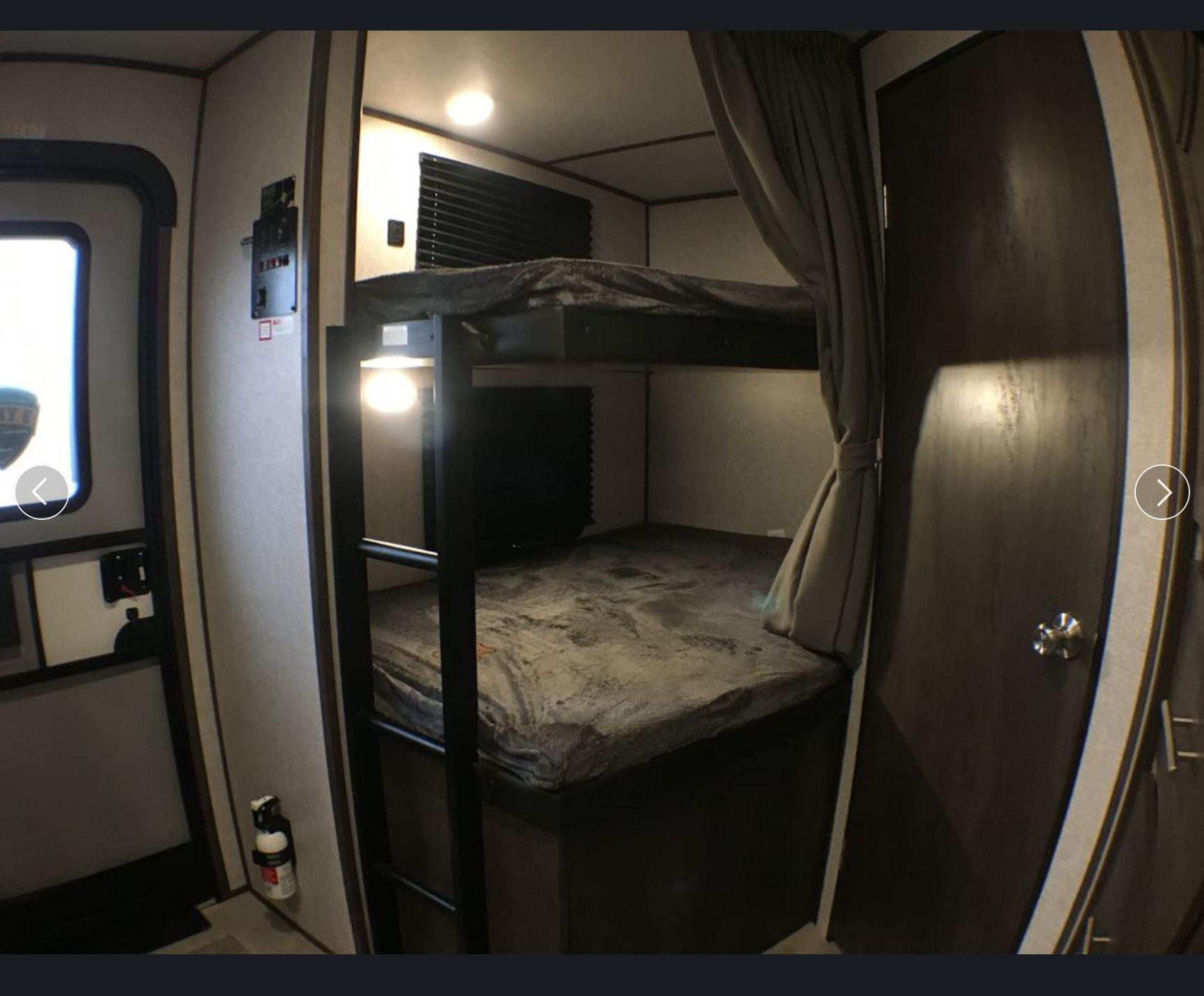 Experience comfort in this RV rental! Features a cozy bunk bed area with privacy curtains, control panel, and safety extinguisher.. Dutchmen Other 2021