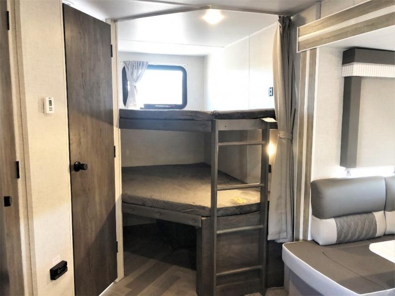 RV rental interior features cozy bunk beds and dinette seating. Perfect for family travel trailers.. Forest River Salem 2021