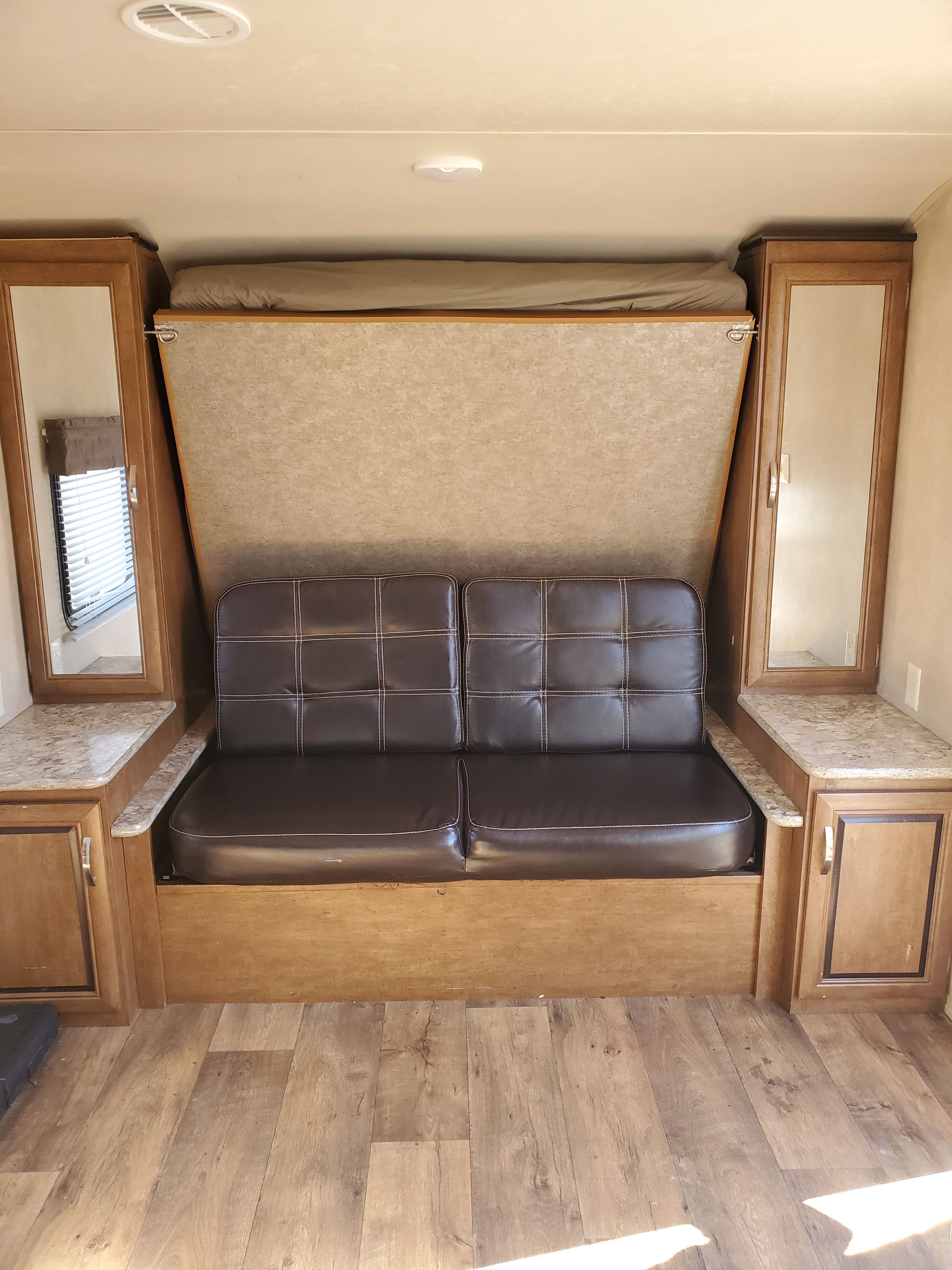 under the murphy bed is a sofa to give you space and seating when you are not sleeping. leave it down or up, it is all up to you.. Forest River Wildwood X-Lite 2016