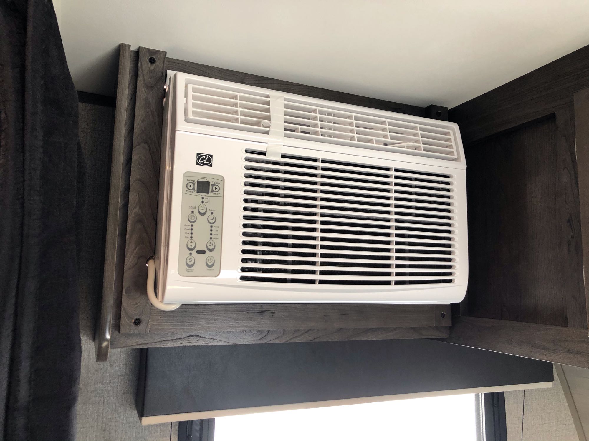 Compact AC unit with digital controls installed in an RV rental's overhead cabinetry, ready for comfortable travel.. Jayco Jay Flight SLX Baja Edition 2021