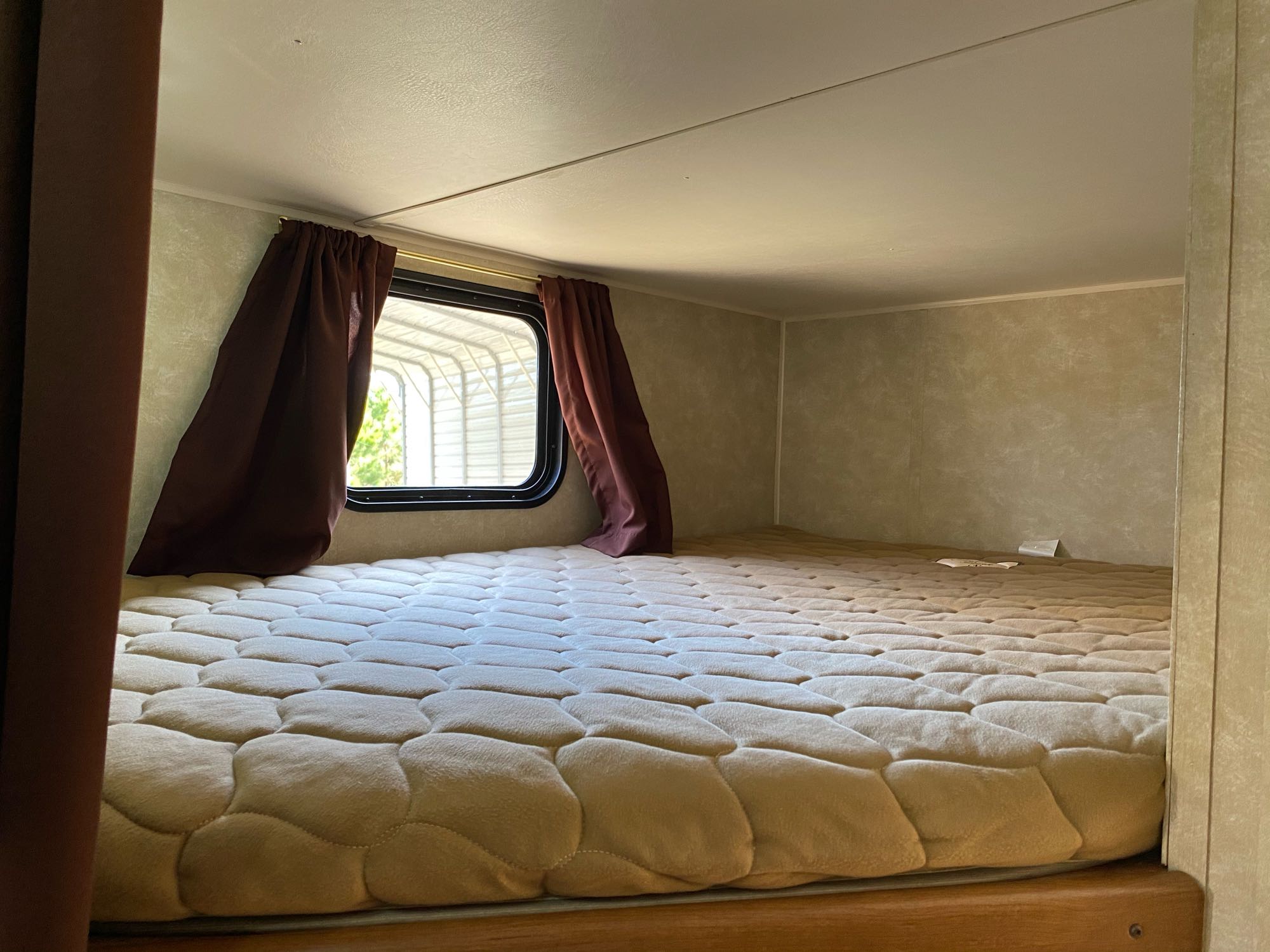 This RV rental bunk bed offers a comfortable sleeping space with a soft, quilted mattress and window.. Gulf Stream Kingsport 2015
