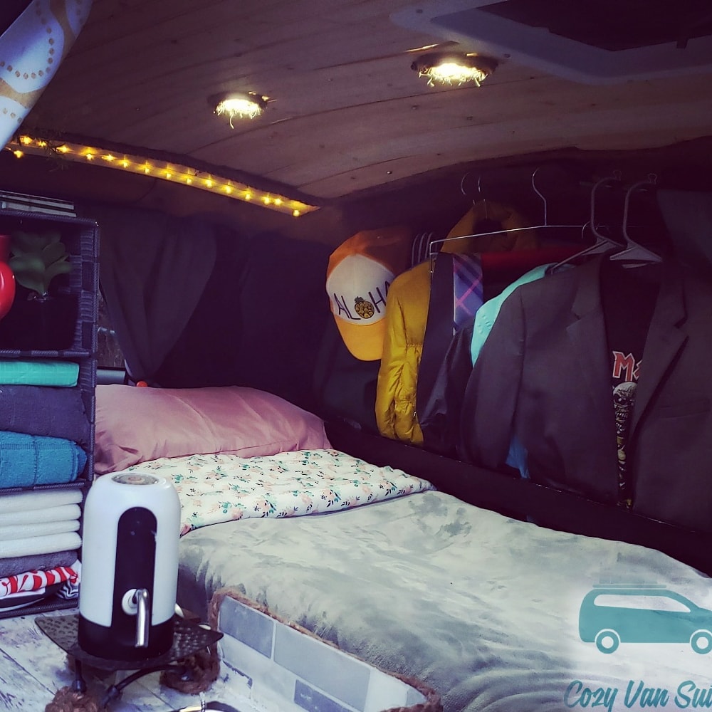 Cozy bedroom with the most comfortable bed and an area to hang your coats, clothes and backpacks. Stealthy Easy on Gas Minivan Camper 2005