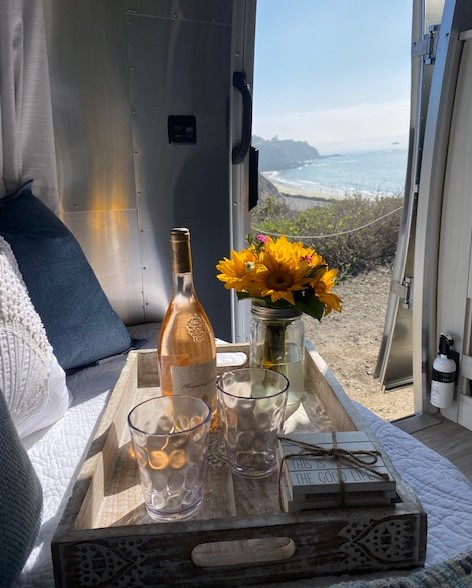Relaxing RV rental view! Enjoy wine, flowers, & the ocean from inside this cozy Airstream, 'This is the good life'!. Airstream Bambi 2021