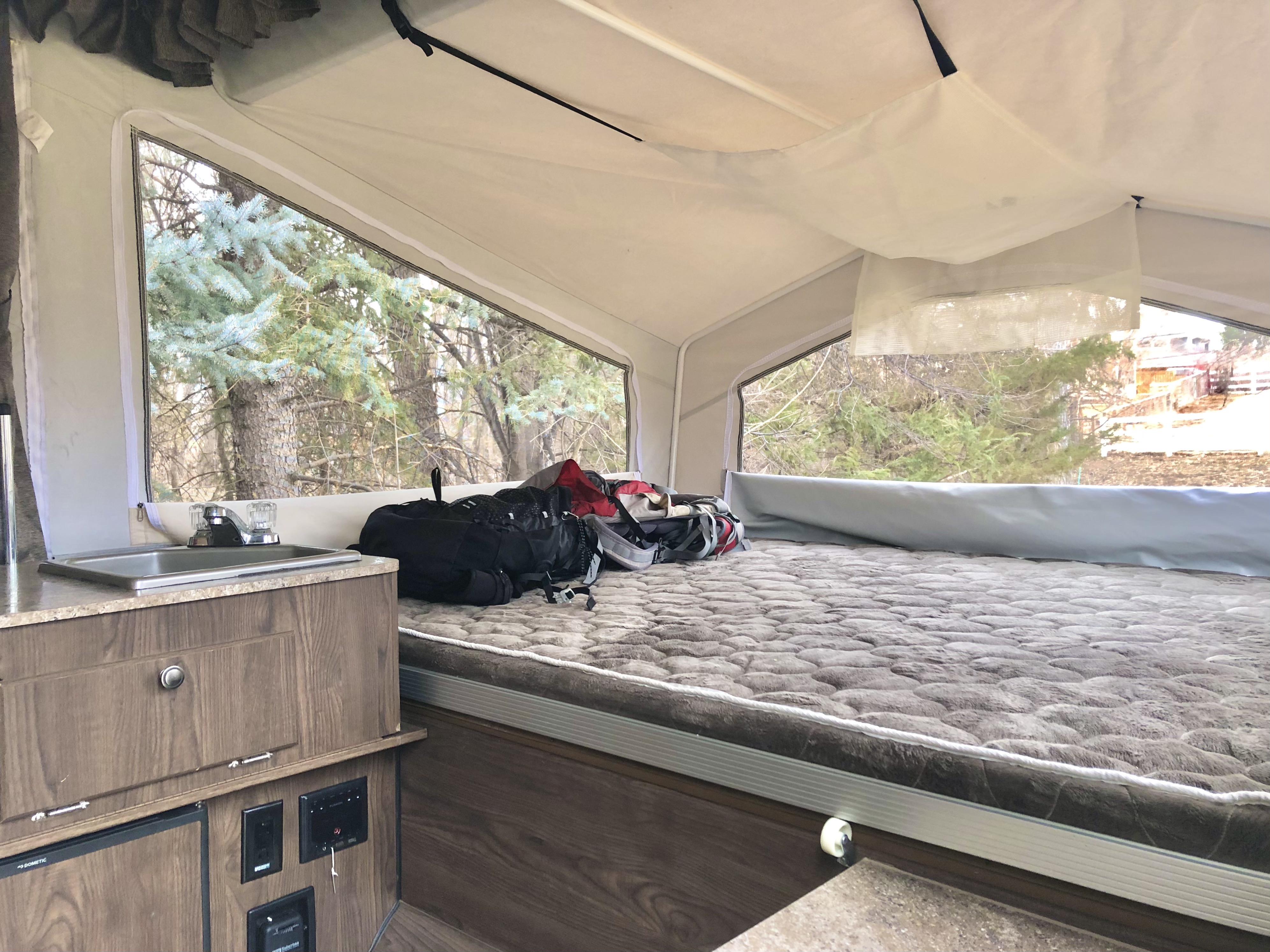 This is the bed with the FullXL mattress thats very comfortable at 5" thickness.
Features overhead mesh gear slings with pockets for clothes, & gear.. Forest River Rockwood Freedom 2018