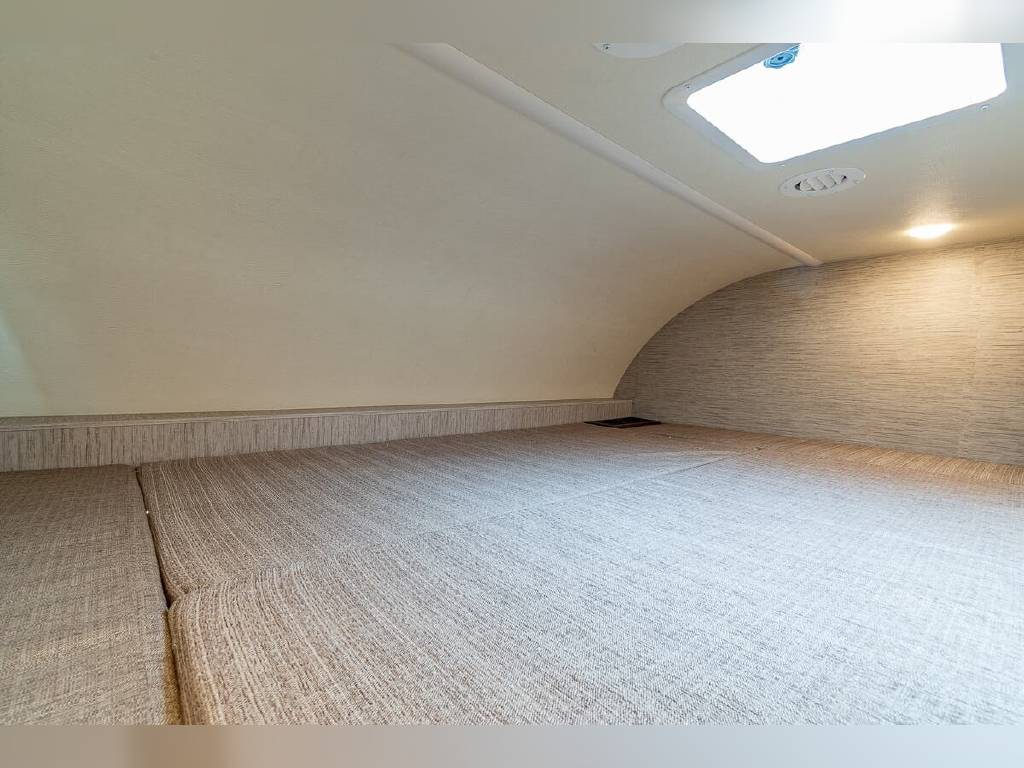 Comfortable RV rental bed/bunk area, with a bright skylight & overhead light. Perfect for travel.. Thor Motor Coach Chateau 2020