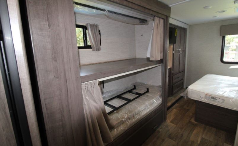 New RV rental interior featuring bunk beds, a master bed, and storage for family comfort.. Winnebago Minnie Winnie 2022