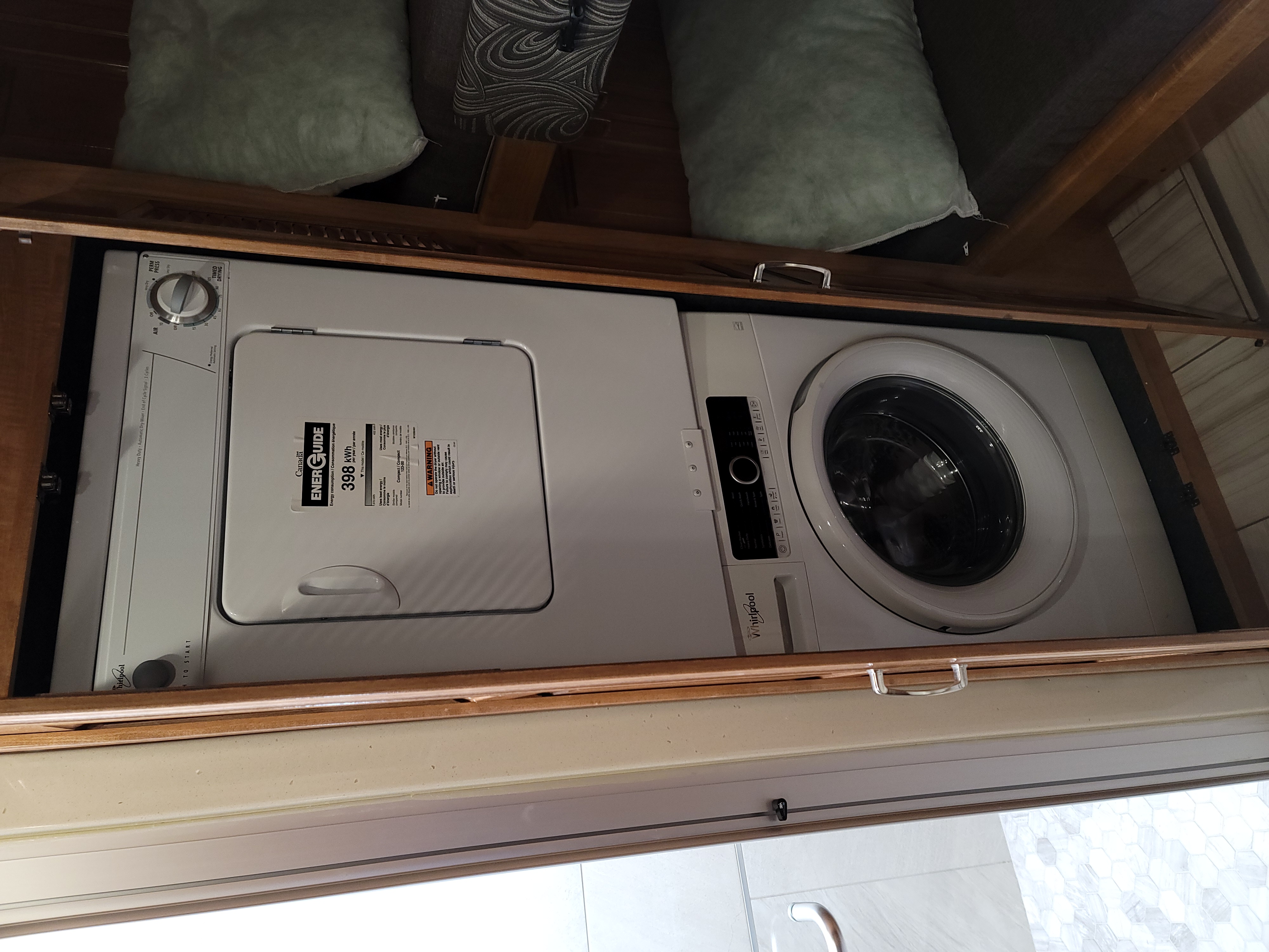 Whirlpool stackable washer & dryer in an RV rental, offering compact laundry convenience.. American Revolution 2019