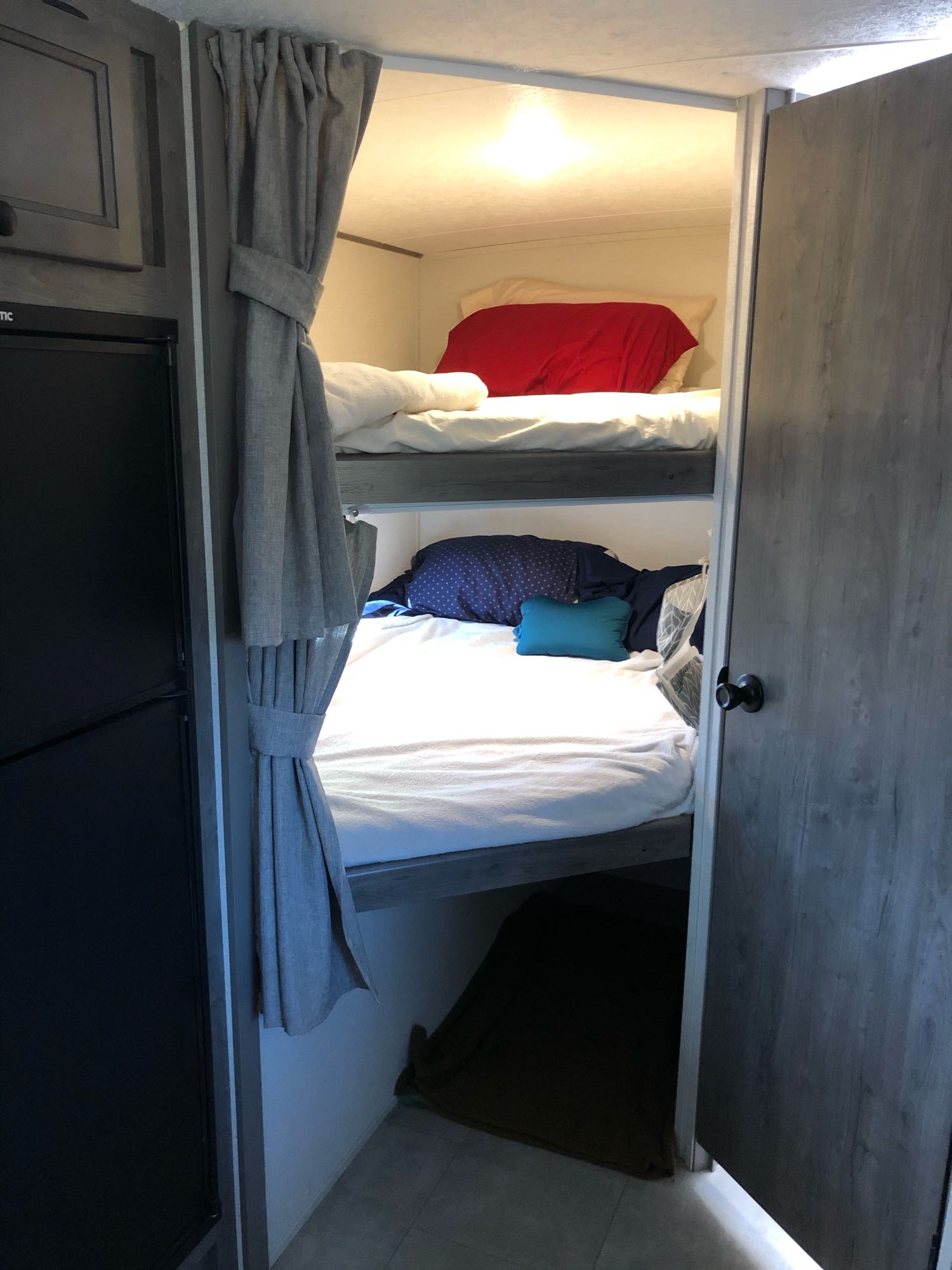 Step inside this RV rental's sleeping area featuring comfortable bunk beds with privacy curtains. Ideal for family travel.. Other Other 2021