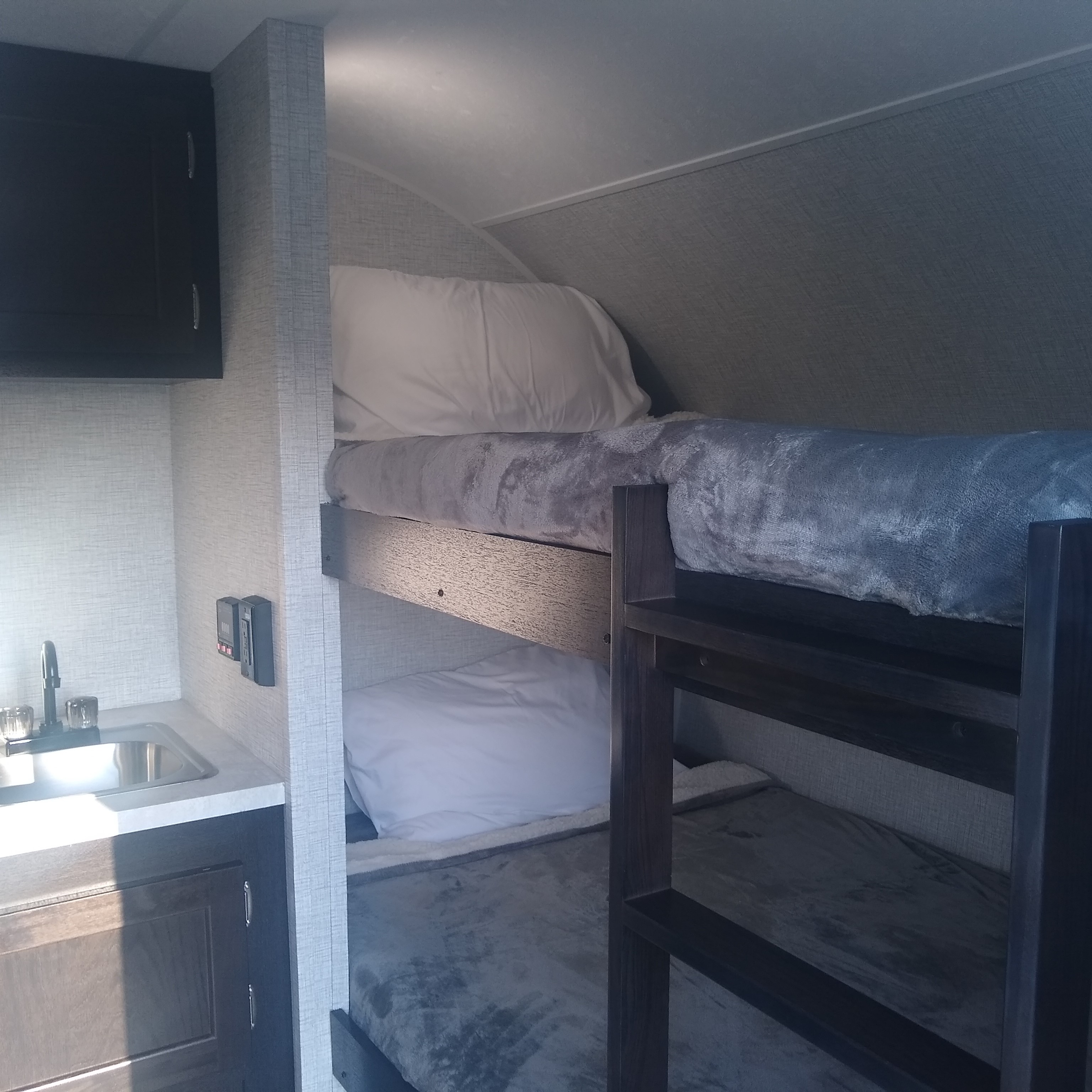 Dual twin-sized bunk beds with storage underneath. Braxton Creek Bushwhacker 17BH 2021