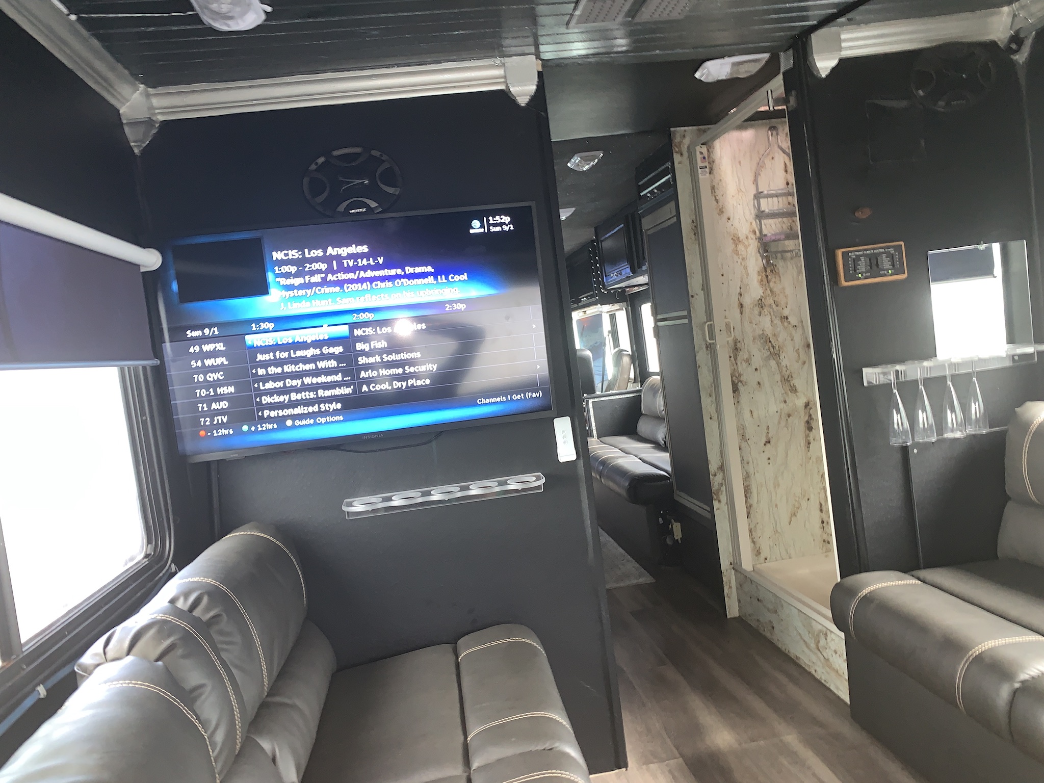 Inside a comfortable RV rental: plush seating, large screen TV displaying NCIS, and a spacious travel lounge for entertainment.. Fleetwood Other 2015