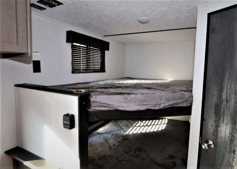 Experience comfort in this rv rental. View of a bunk bed setup with a window, charging port, and natural light.. Keystone Hideout 2021