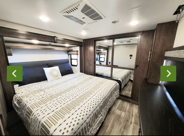 Spacious and modern RV rental bedroom with comfortable bed, mirrored closet, and ample storage. Perfect for travel.. KZ Recreational Vehicles Durango 2021
