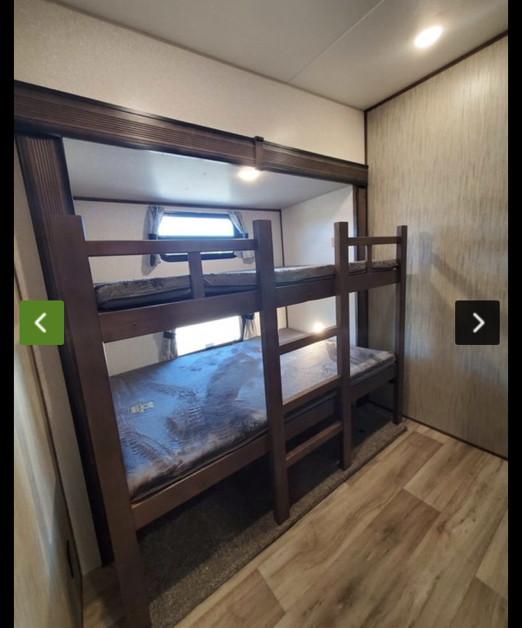 RV rental interior with two dark wood bunk beds and mattresses, ready for sleeping. Ideal for families on the go.. KZ Recreational Vehicles Durango 2021
