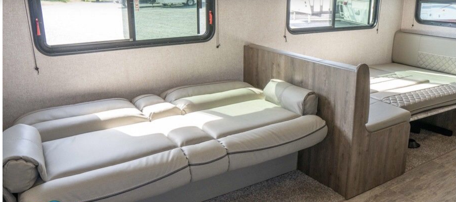 Spacious RV rental interior showcasing a versatile sofa bed and dinette that converts to a bed.. Dutchmen Aspen Trail 2020