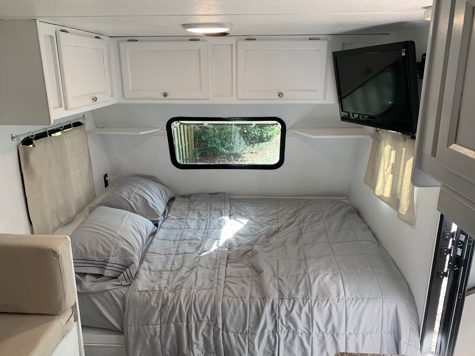 Full size bed with new linens and a mattress cover. . Coachmen Clipper 2018