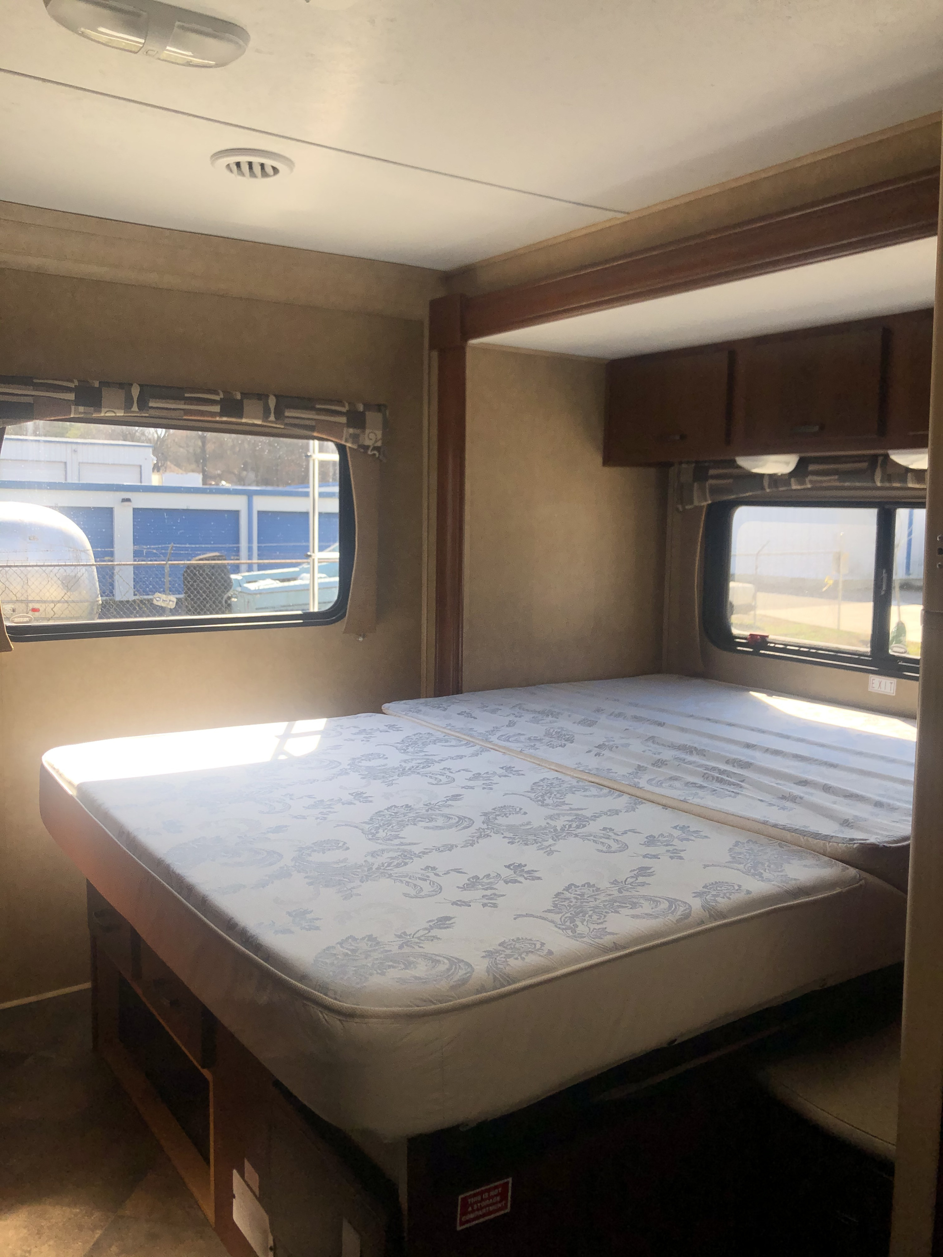 Explore a cozy RV rental: features a bright, convertible sleeping area with windows, ideal for a camper trip.. Forest River Sunseeker 2014